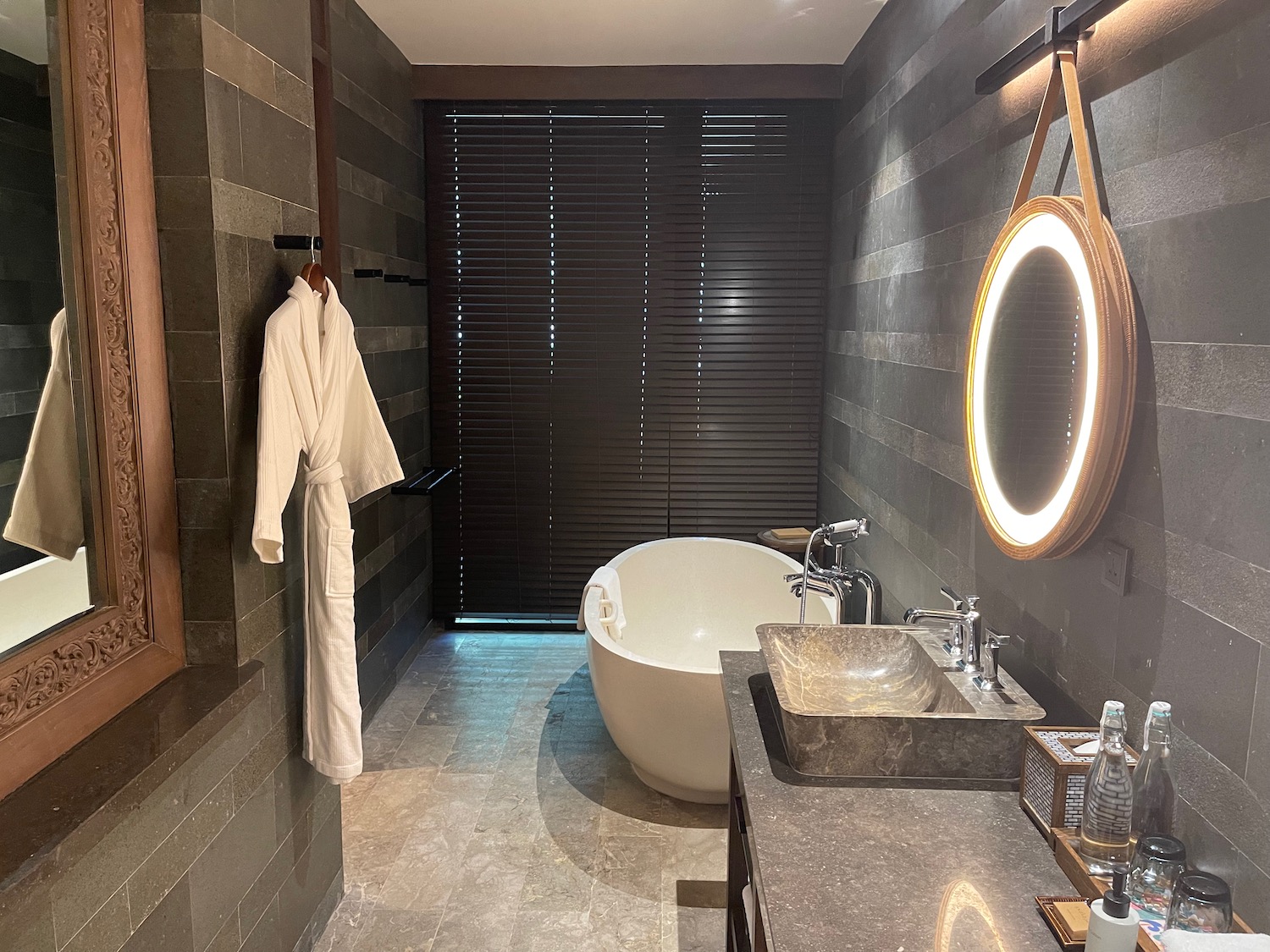 a bathroom with a bathrobe and sink