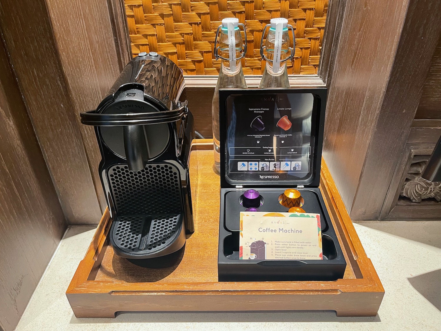 a coffee machine and a container on a tray