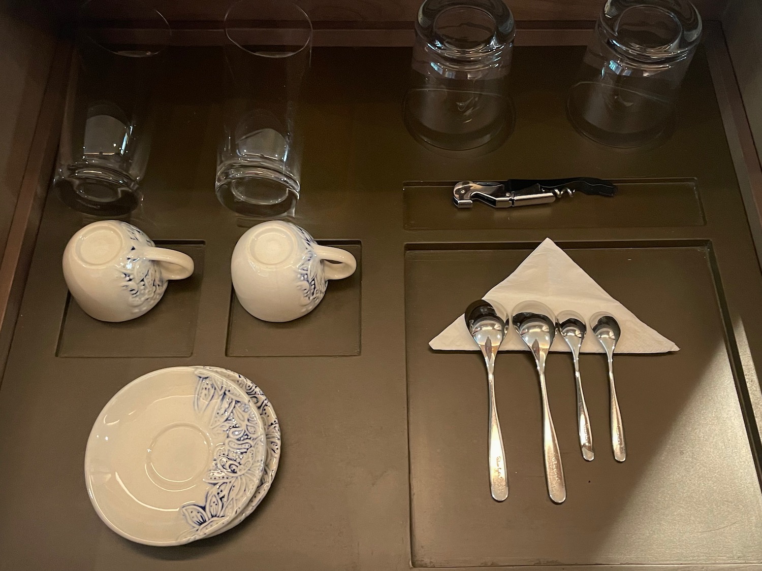 a table with a group of glasses and teacups