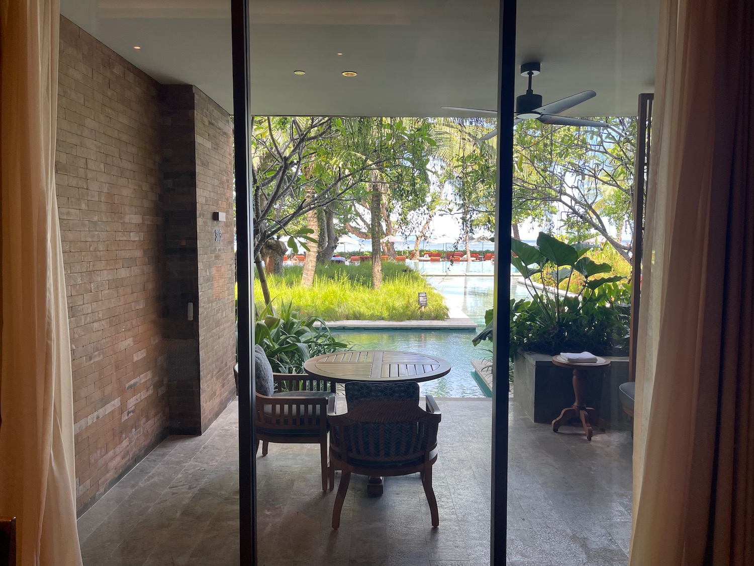 a glass door to a patio with a table and chairs