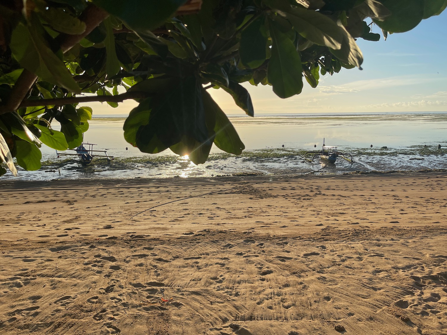 a beach with boats and water