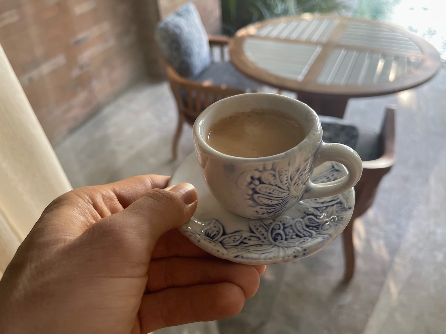 a hand holding a cup of coffee