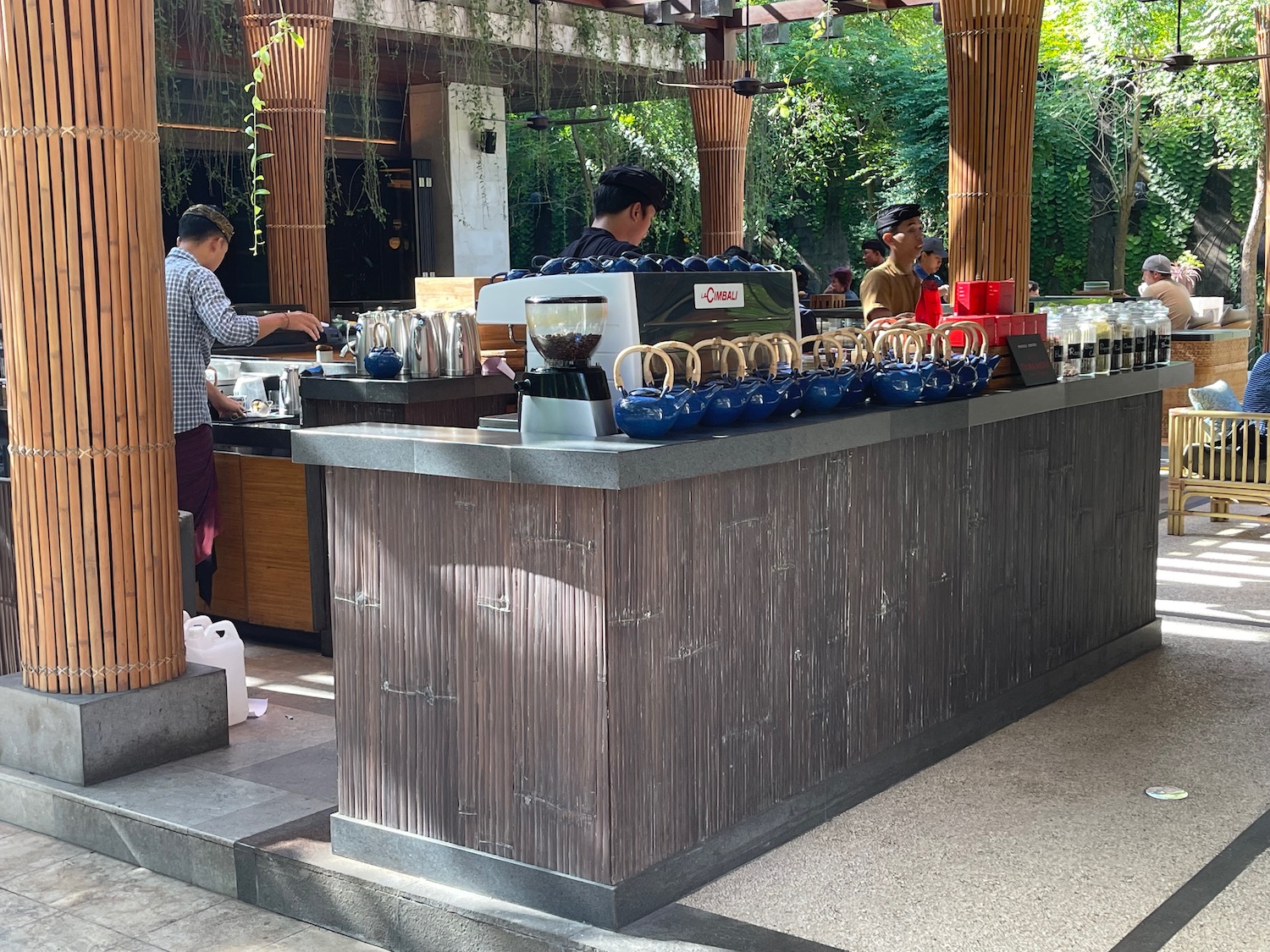 a counter with blue pots and coffee maker