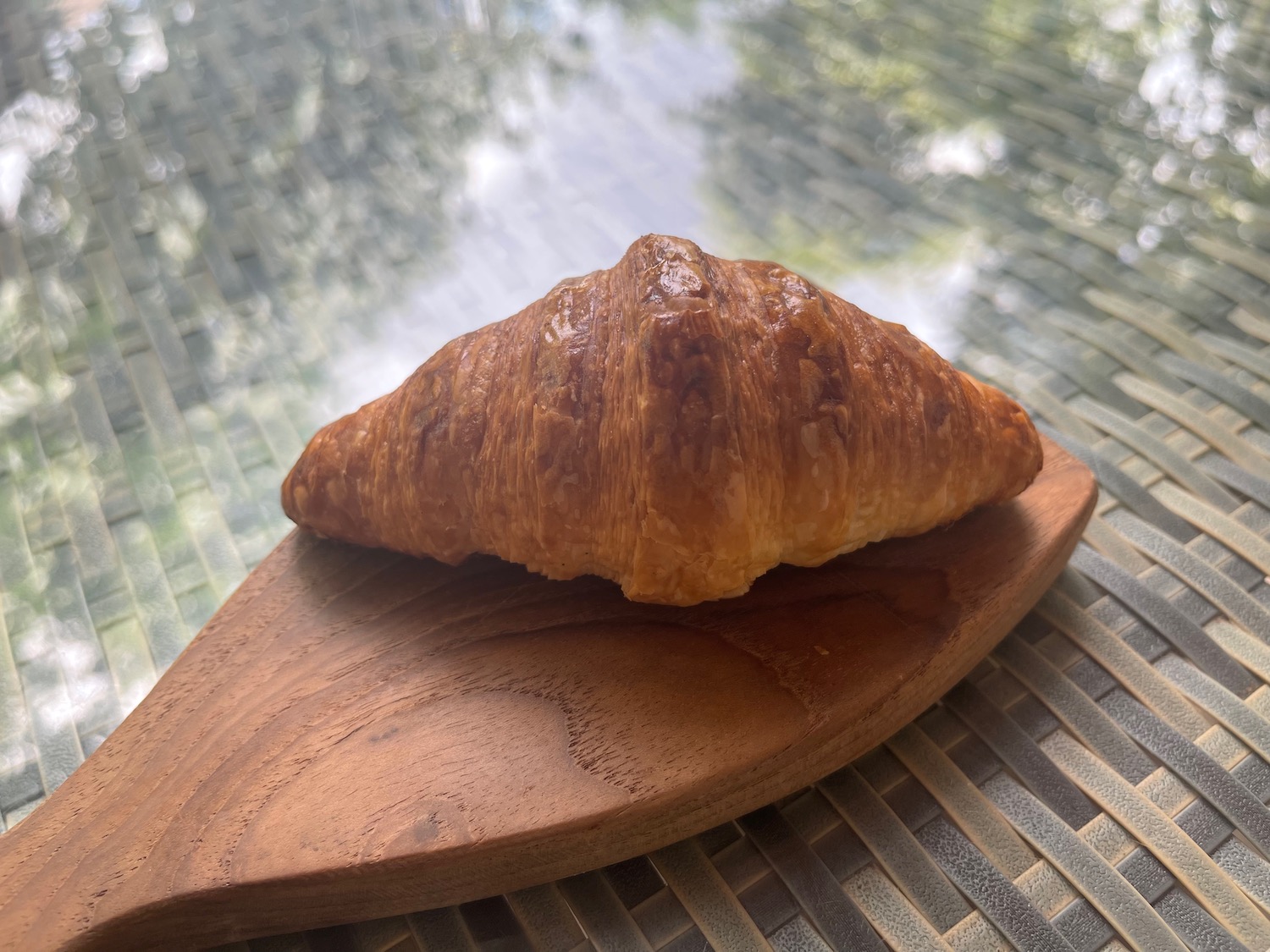 a croissant on a wooden board