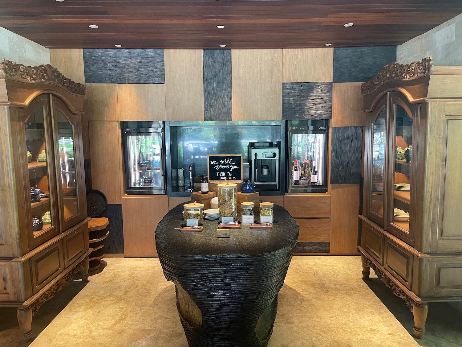 a room with a black table and wood cabinets