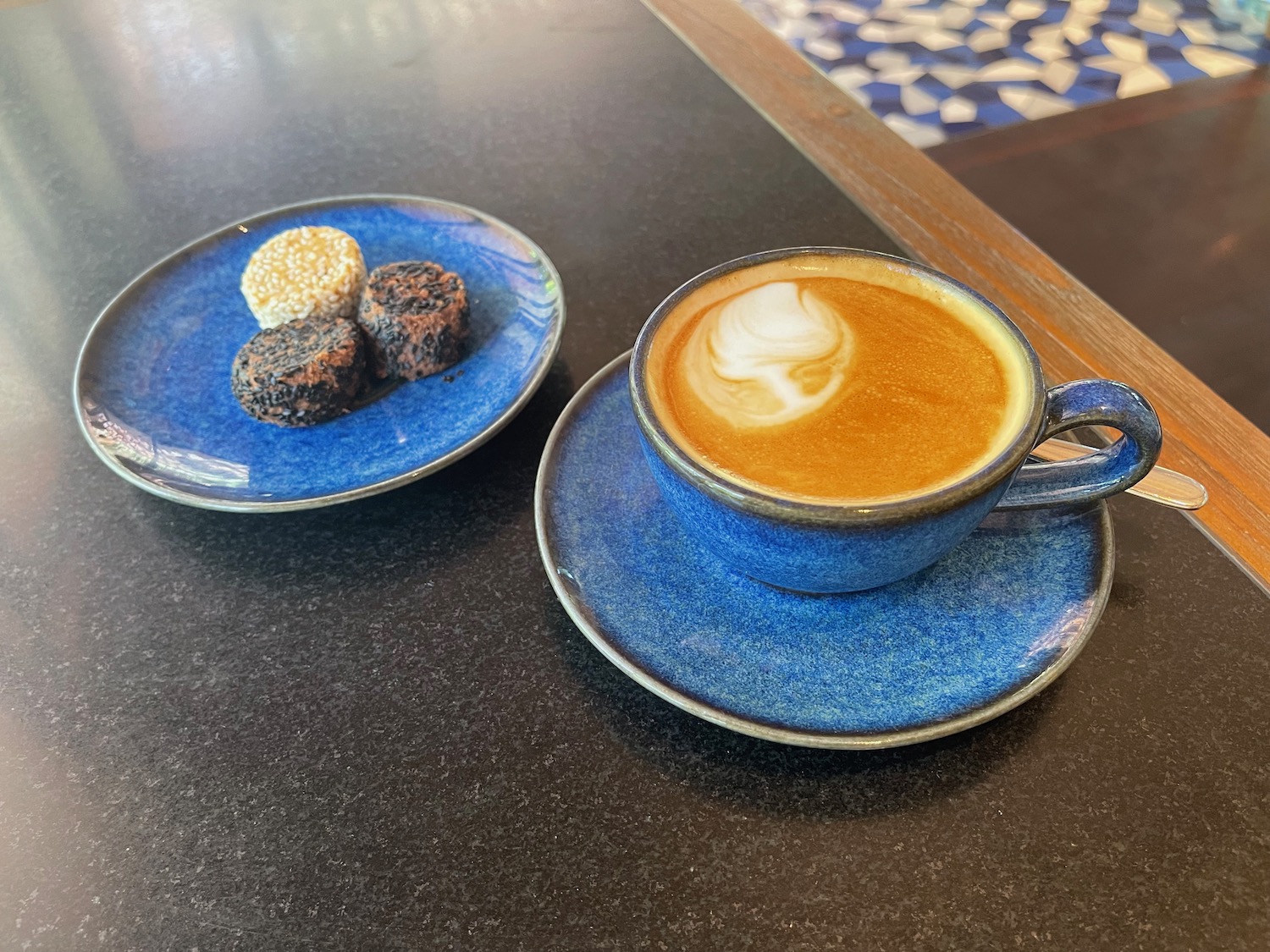 a blue cup of coffee and a plate of food