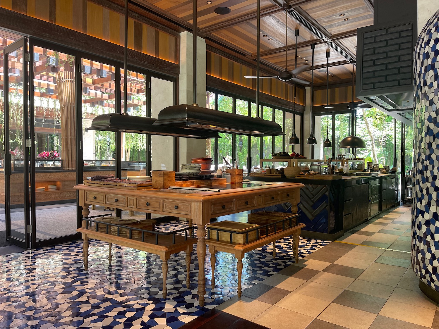 a kitchen with large island and large windows