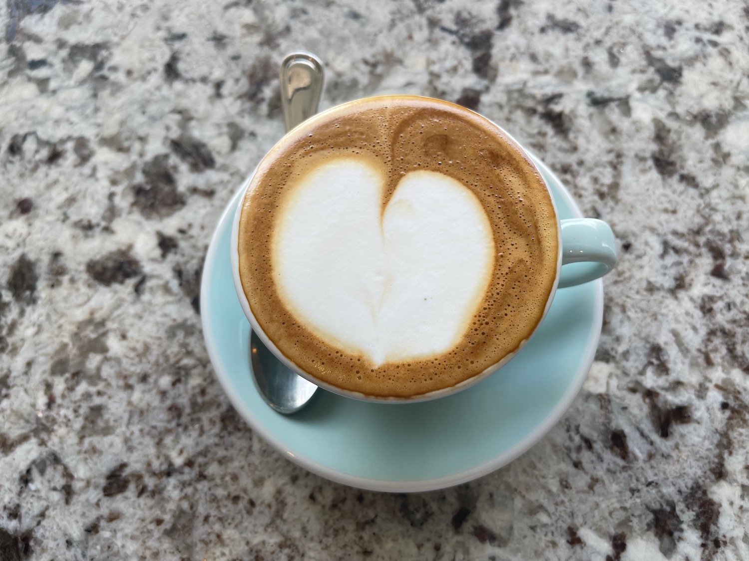 a cup of coffee with a heart in the foam