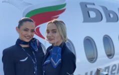 two women standing in front of a plane