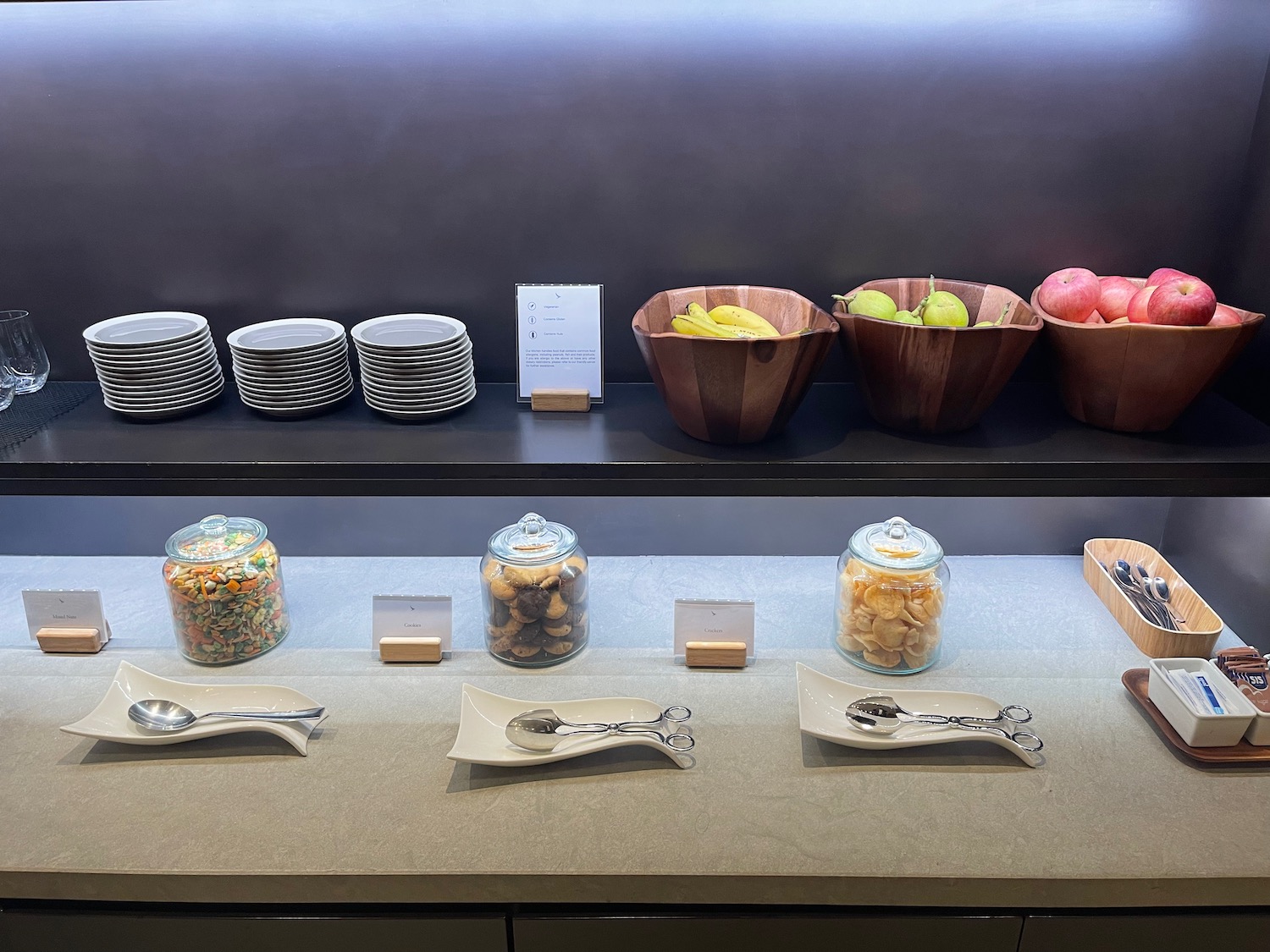 a buffet table with plates and bowls of food