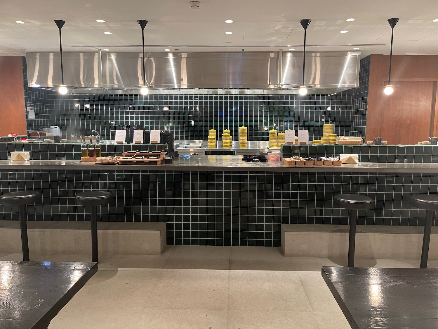 a counter with black tiles and lights