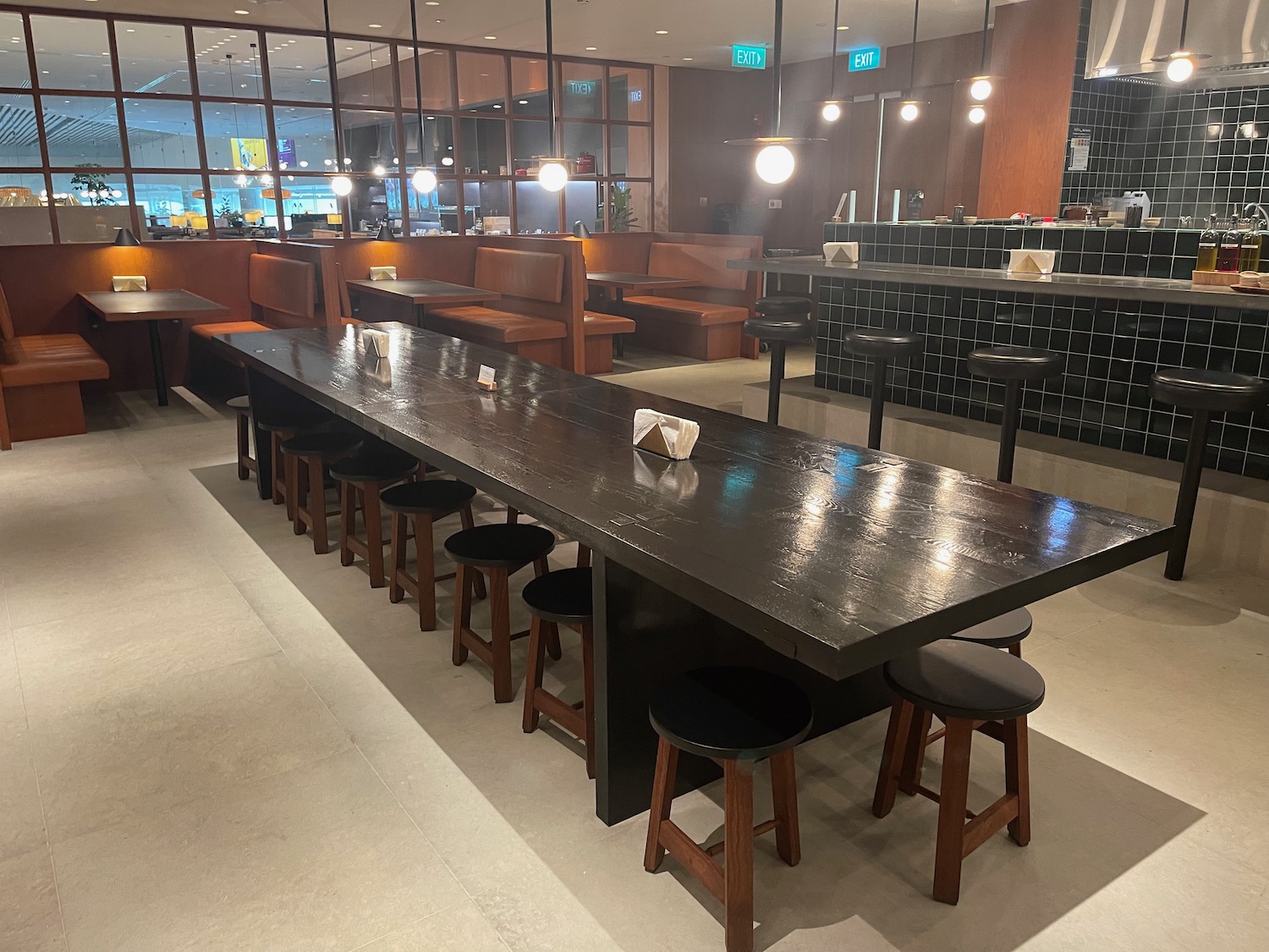 a large table with stools in a restaurant