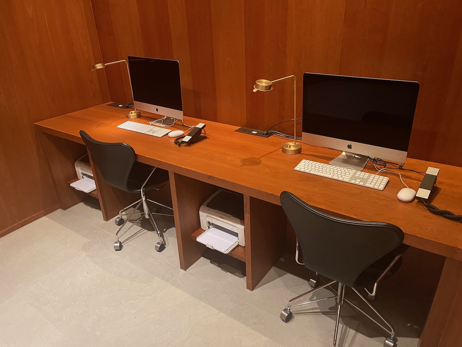 a desk with computers and chairs