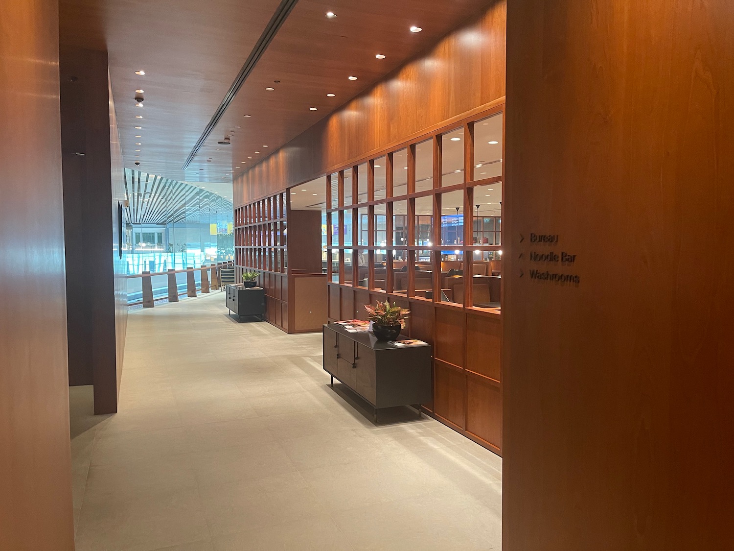 a hallway with wood walls and windows