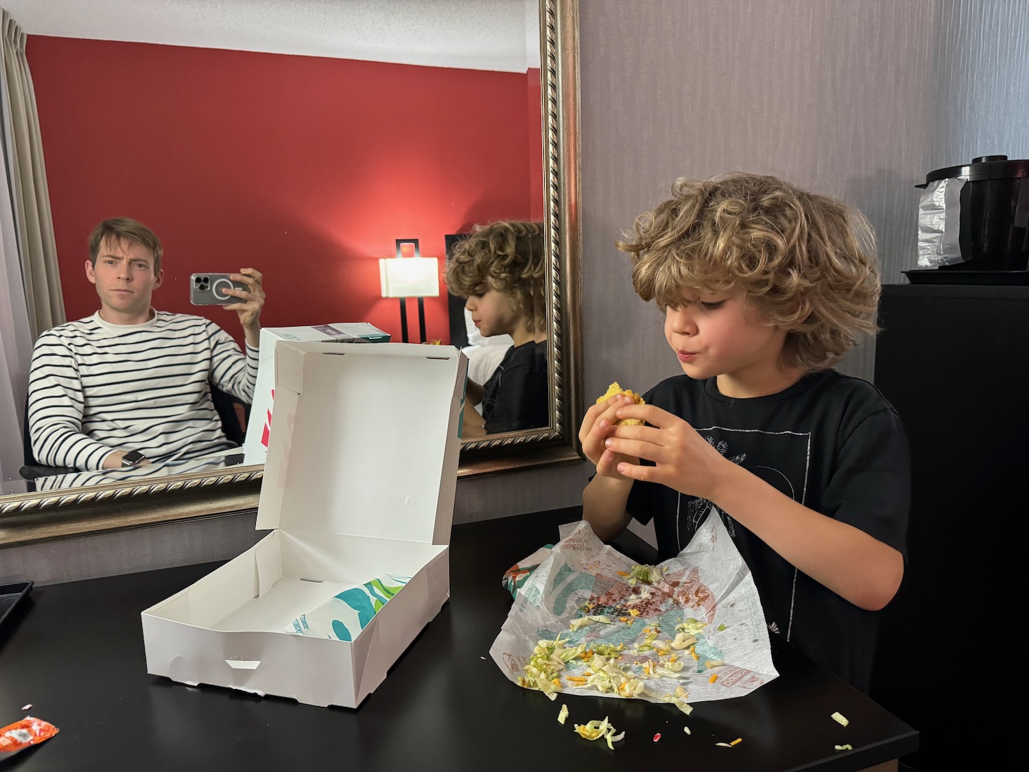 a boy eating a sandwich