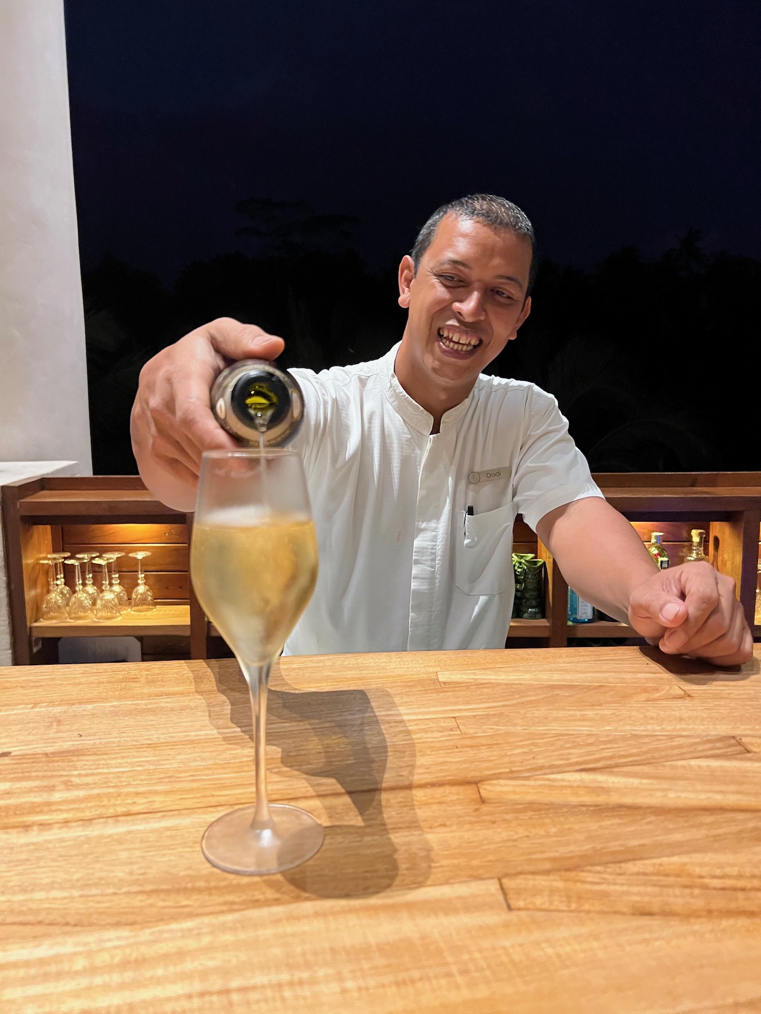 a man pouring a drink into a glass