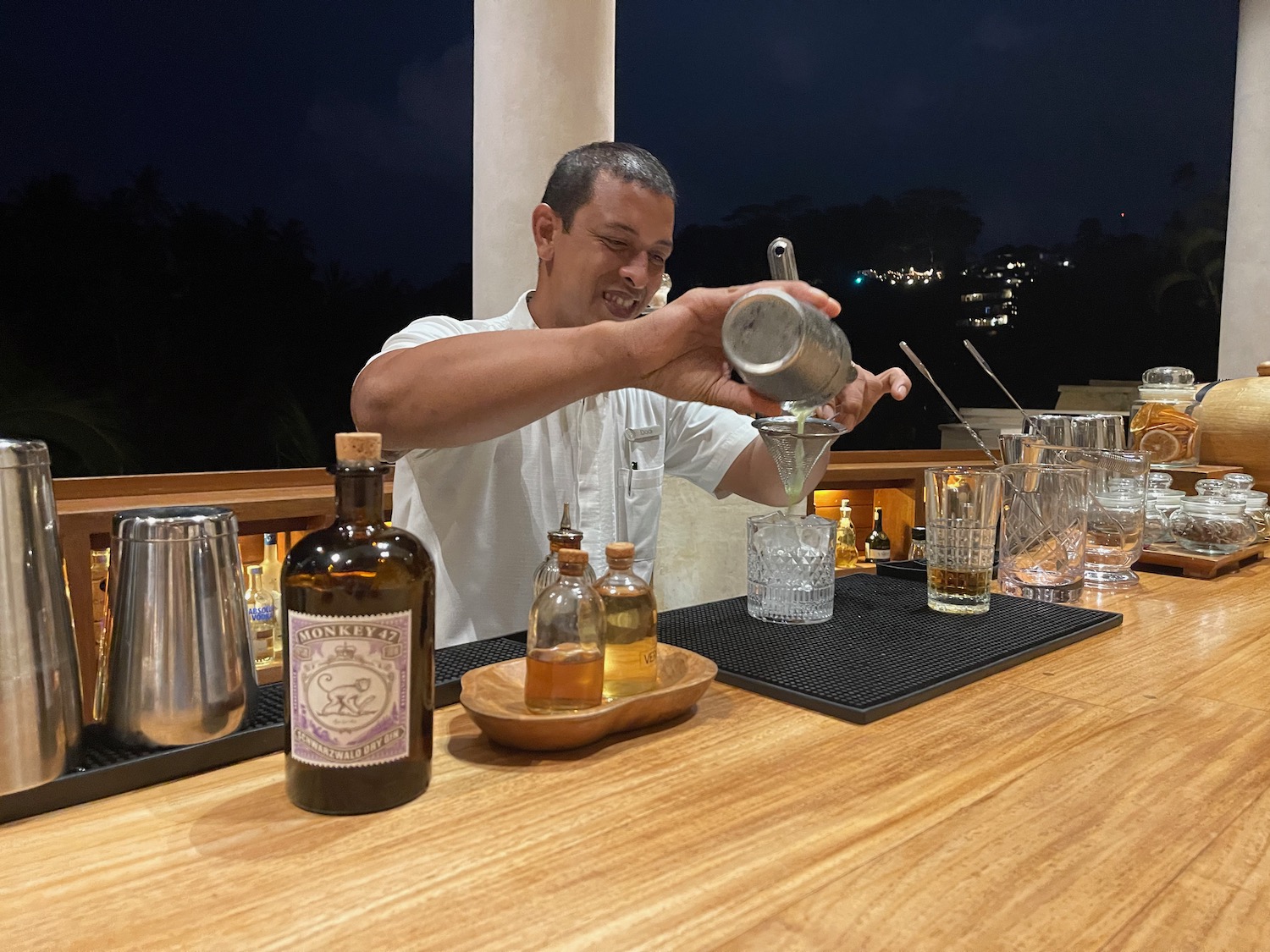 a man pouring a drink into a glass