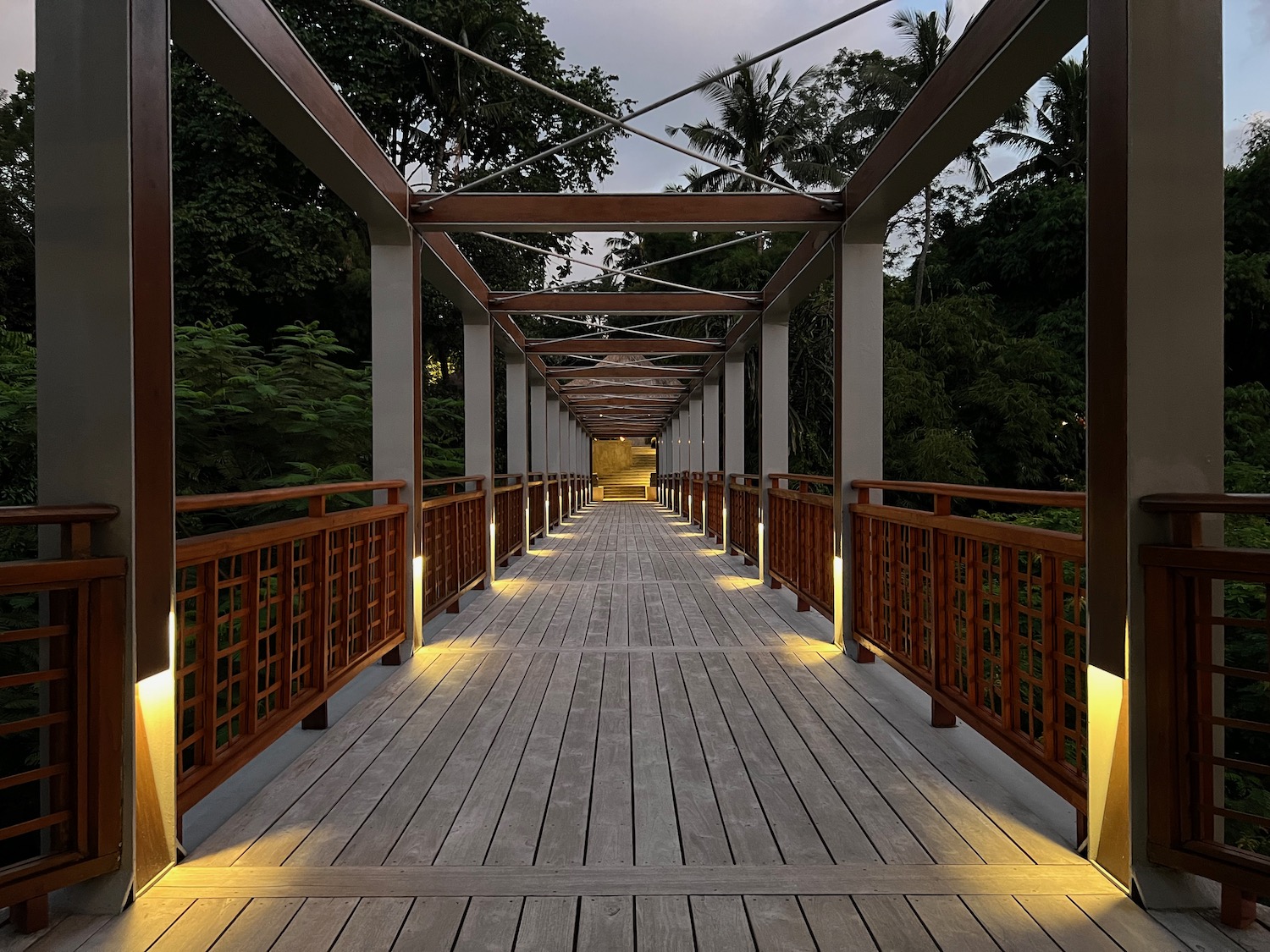 a wooden walkway with lights on