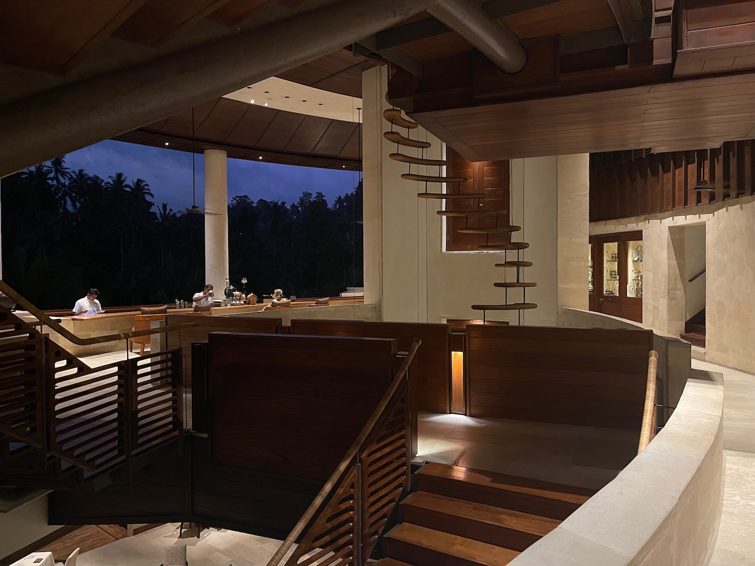 a room with a spiral staircase and a wood bench