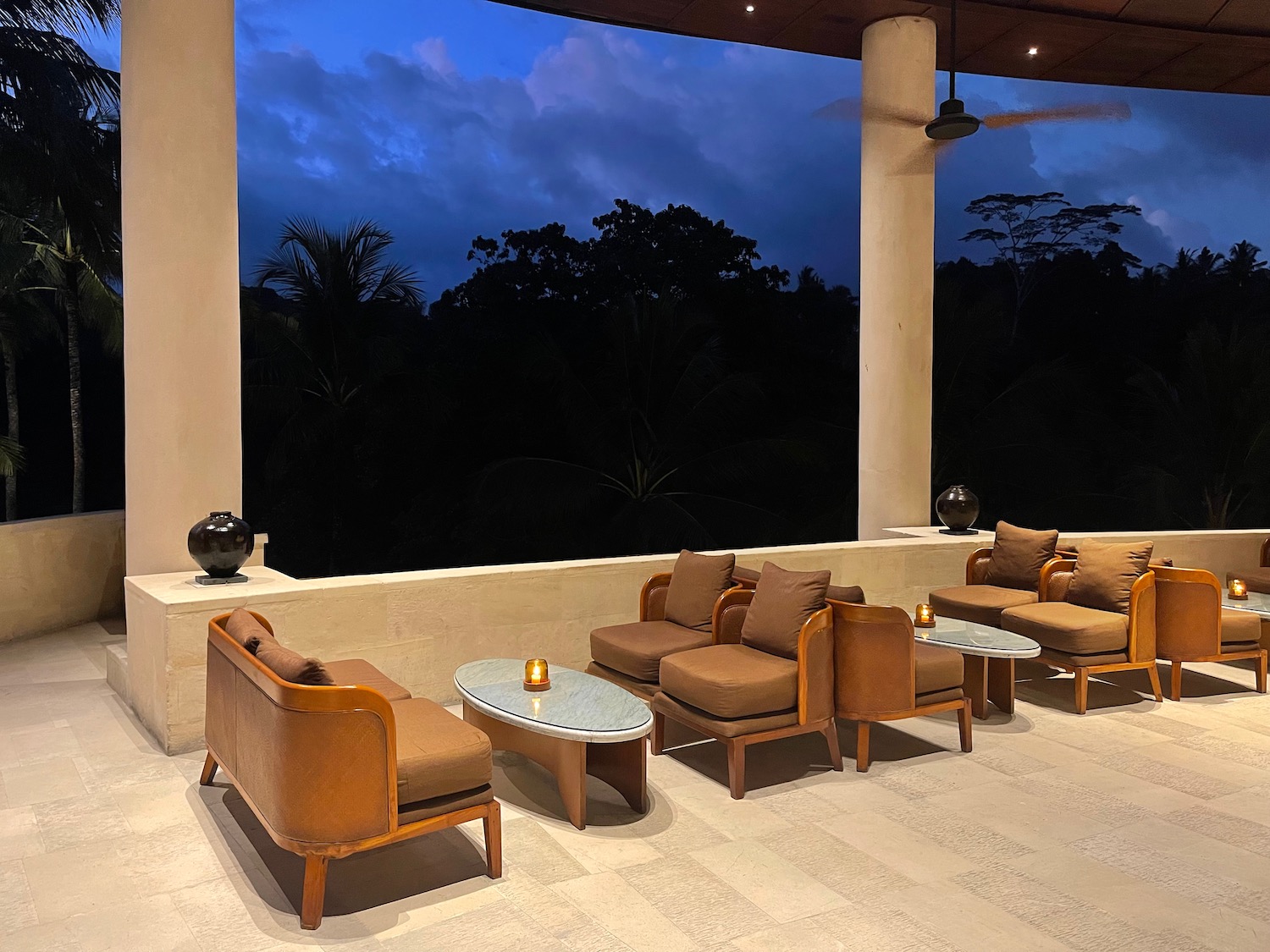 a room with a large window and chairs and tables