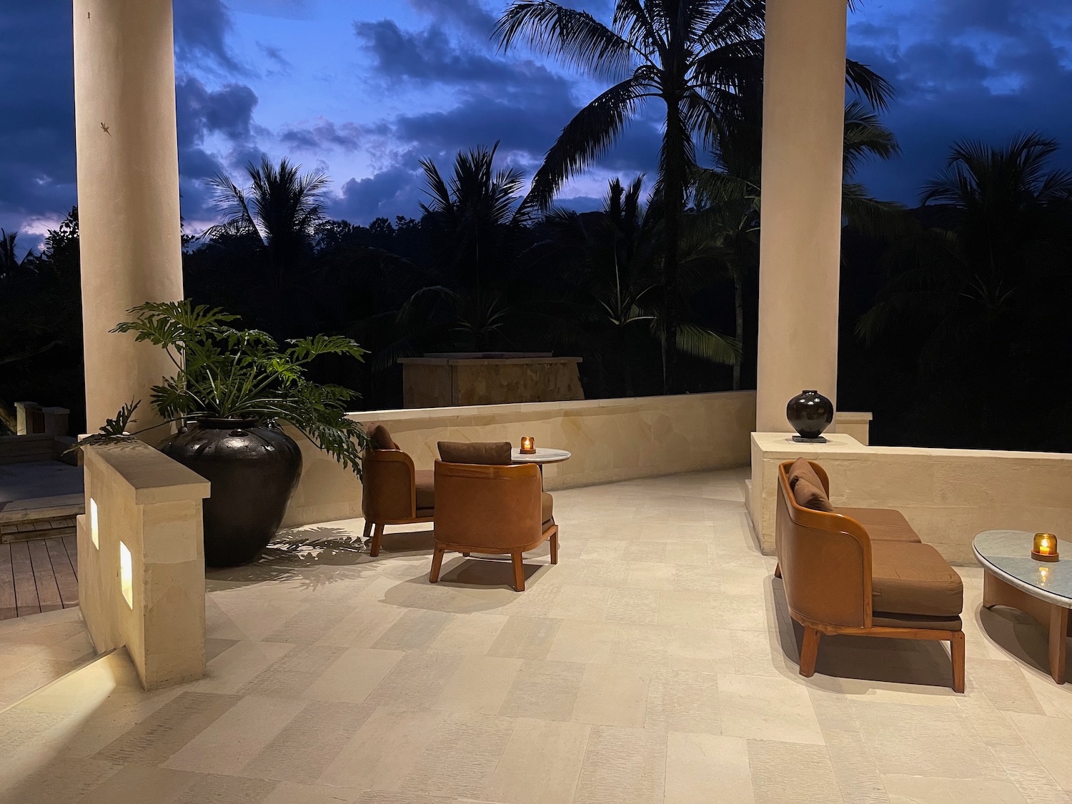 a patio with chairs and a table