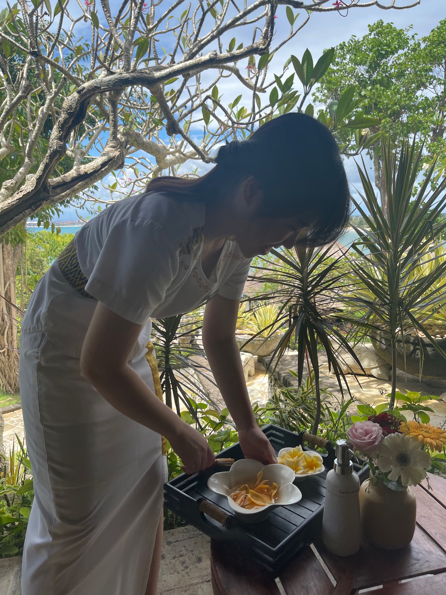a woman in a white dress preparing food