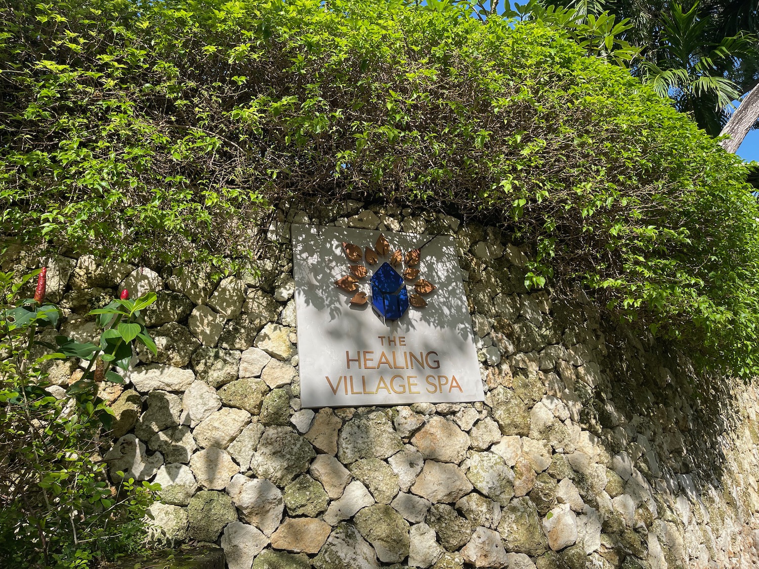 a sign on a stone wall