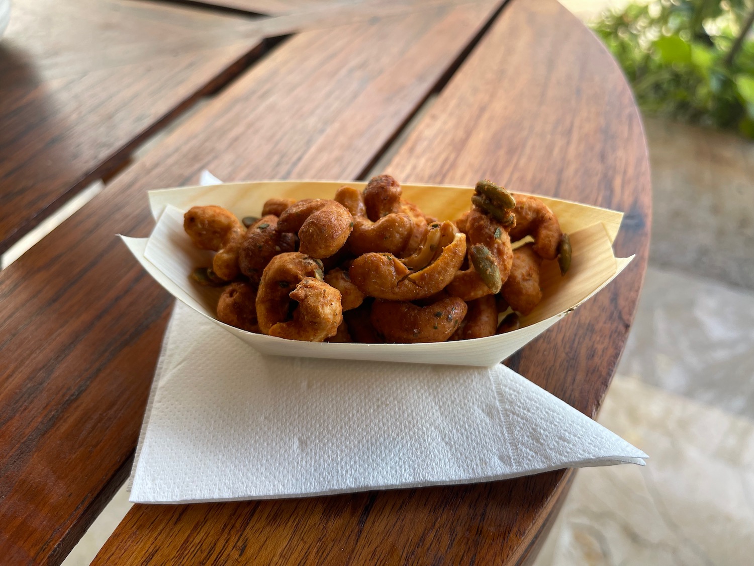 a bowl of cashew nuts on a napkin