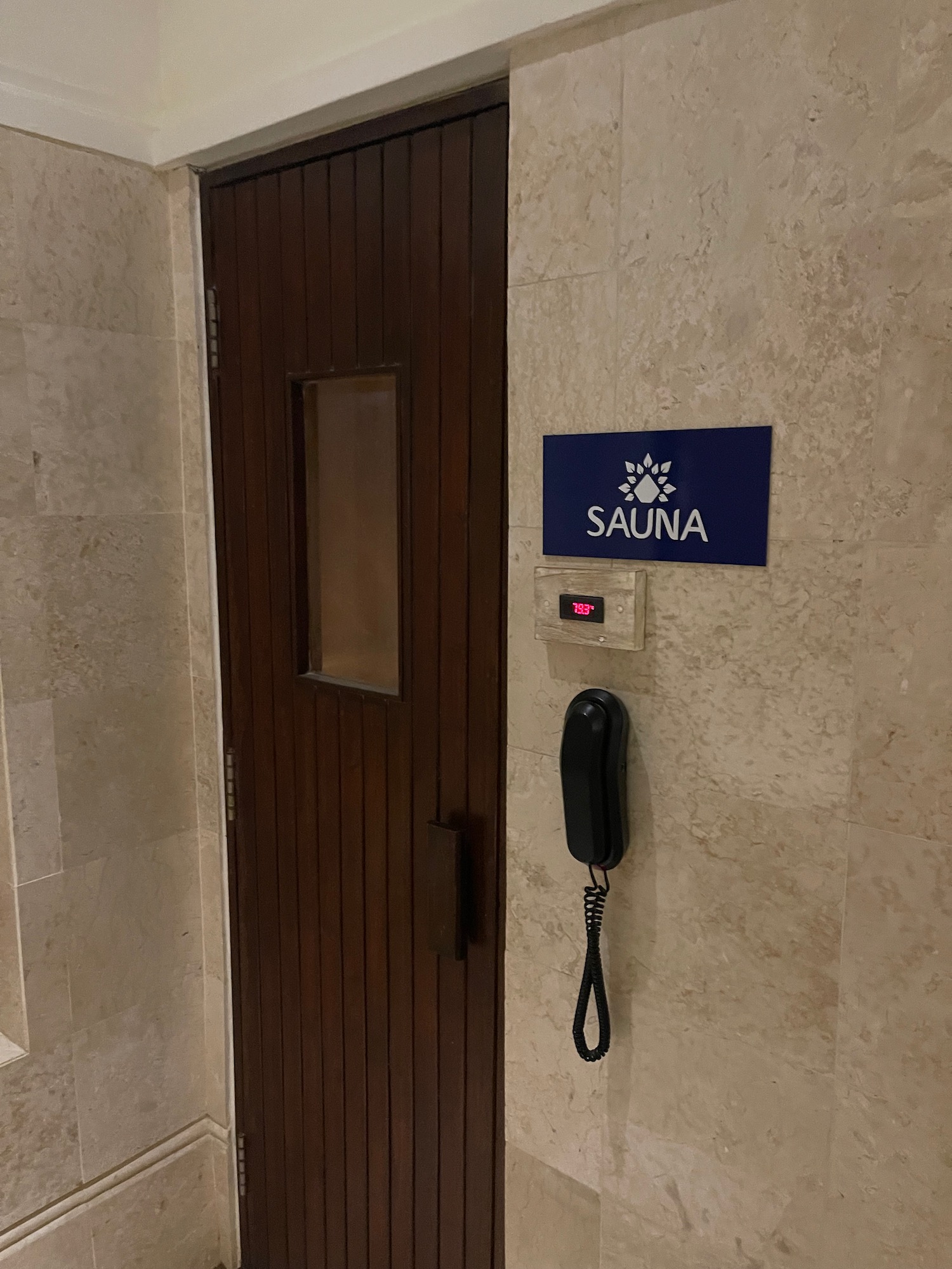 a door with a phone and a sign