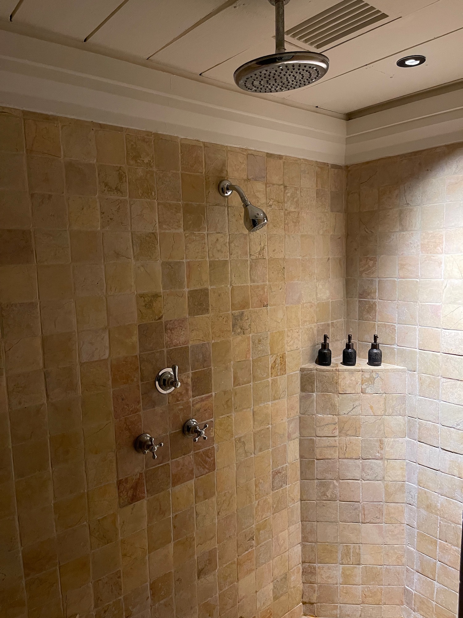 a shower with a shower head and faucet