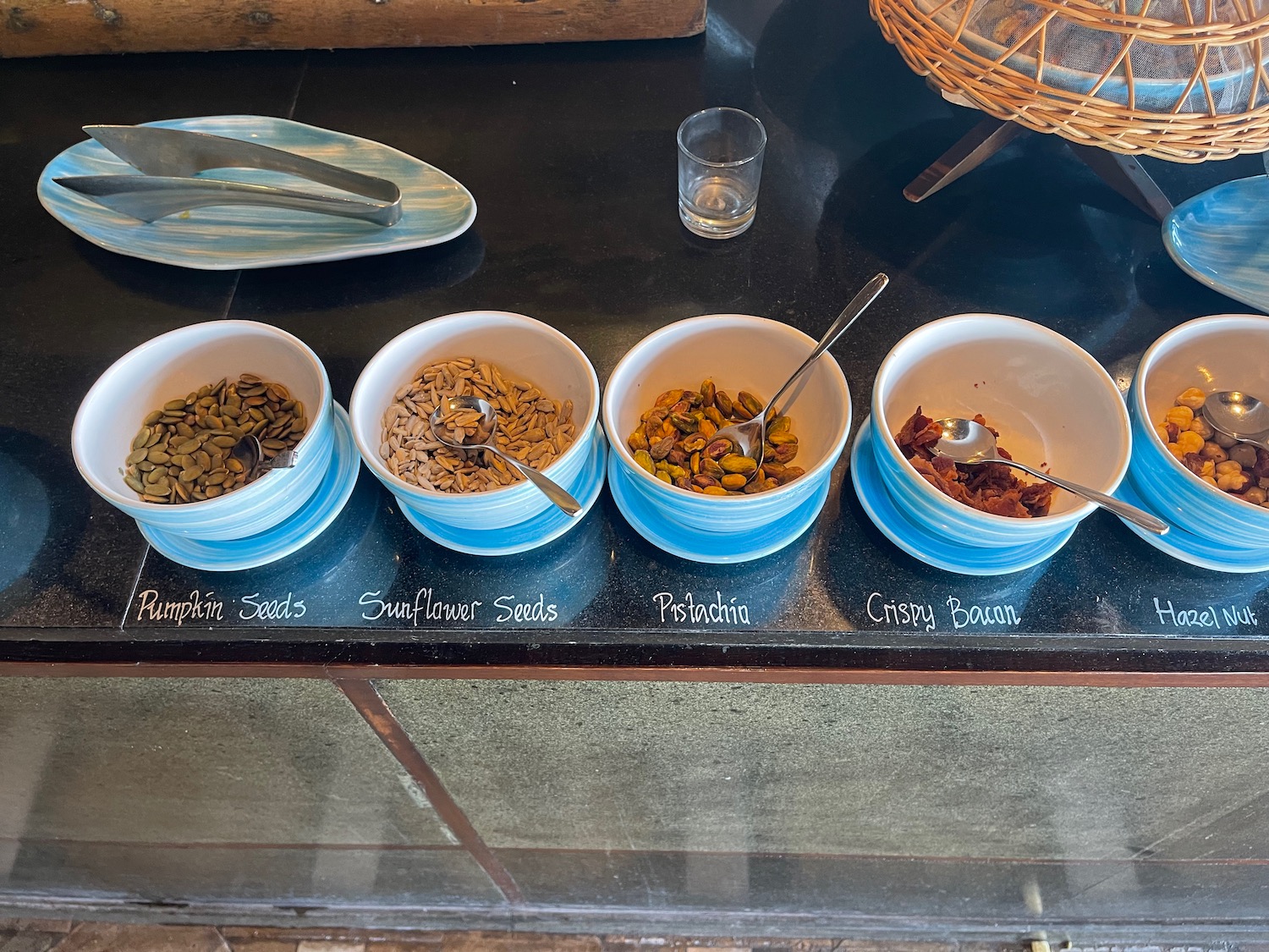 a row of bowls with different types of seeds
