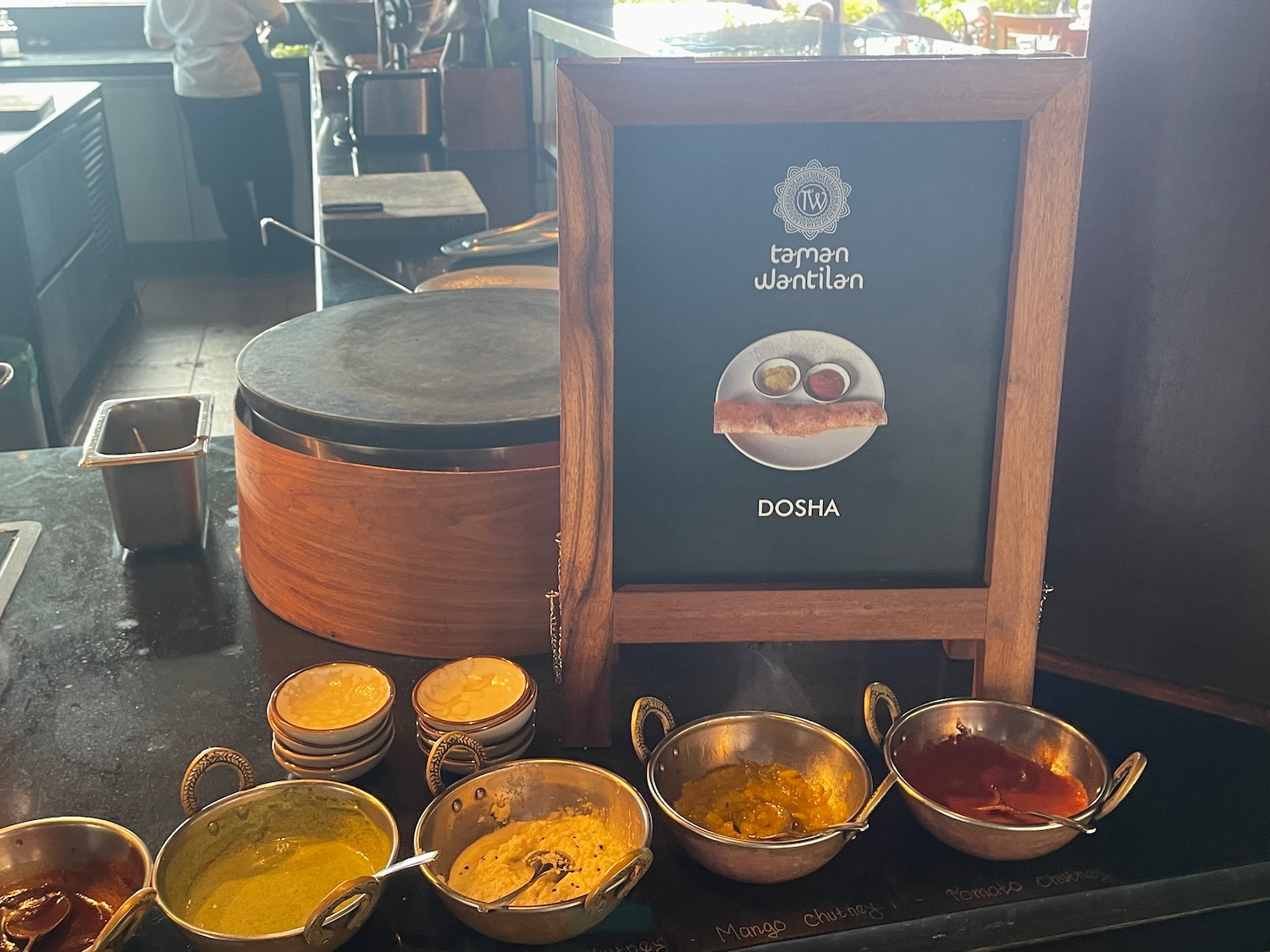 a group of bowls of sauces on a table