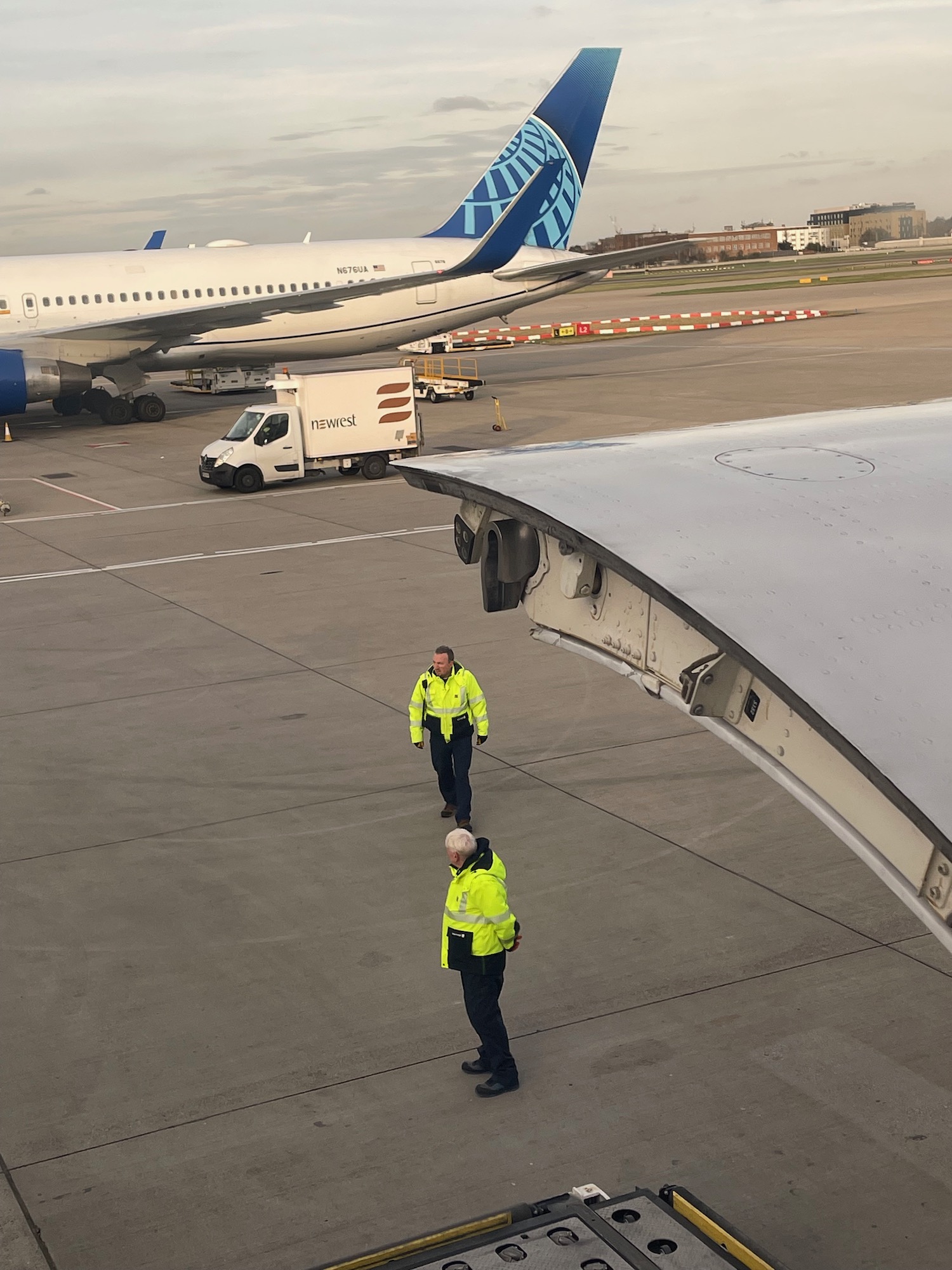 two men standing on a runway