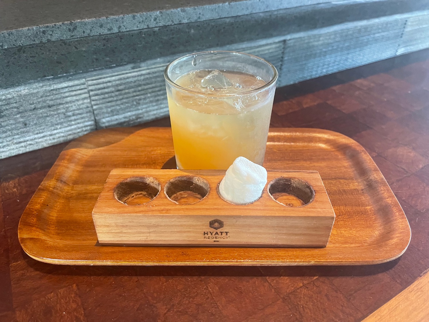 a wooden tray with a drink and a drink in it