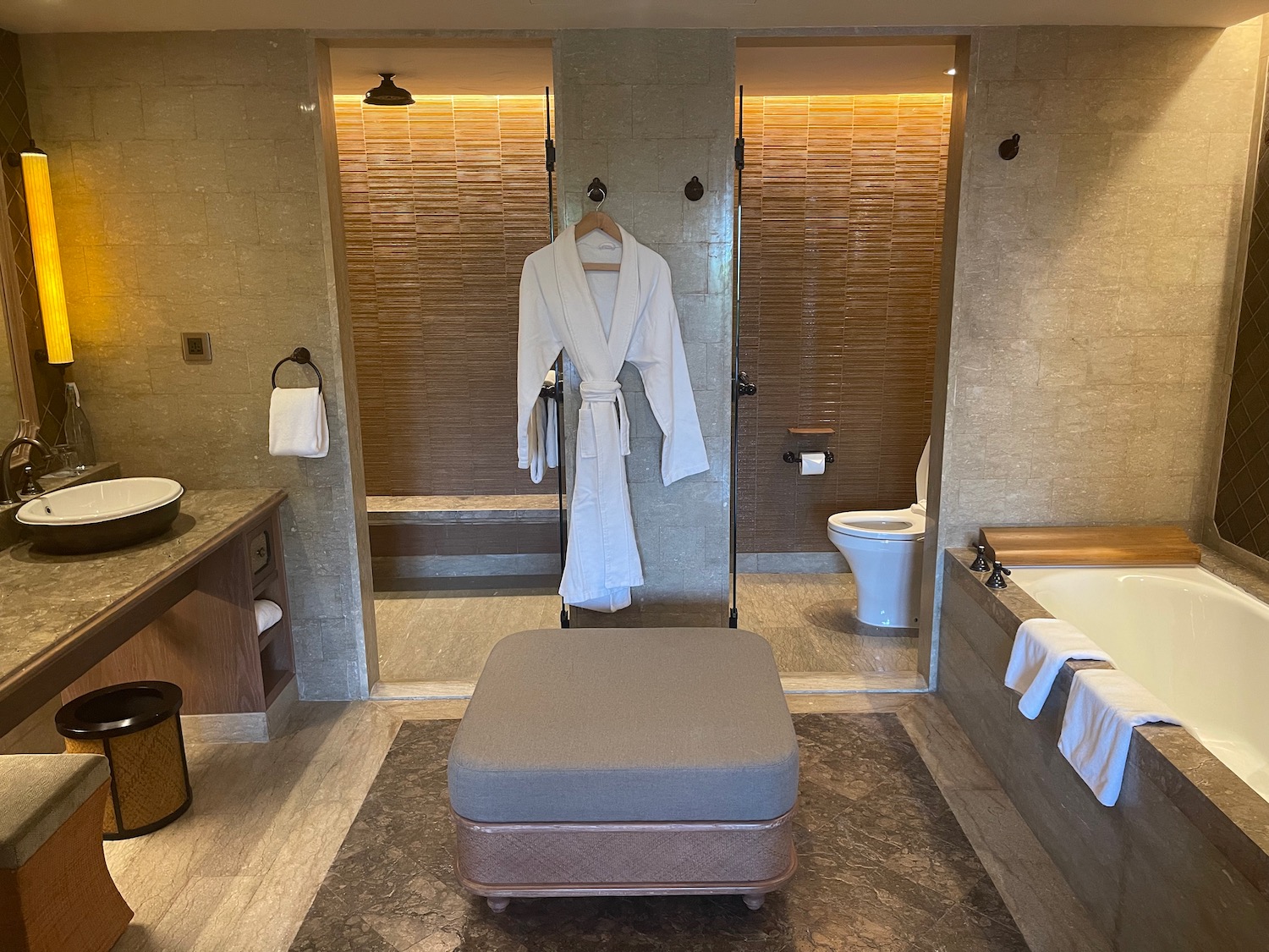 a bathroom with a bathrobe and tub