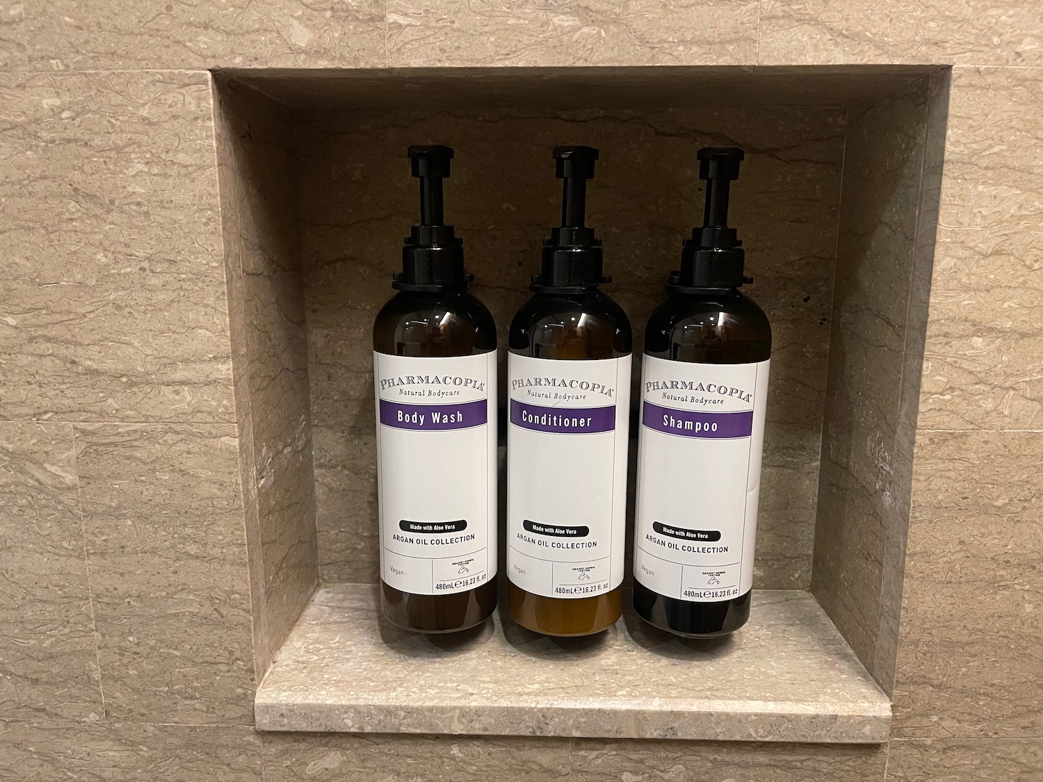 bottles in a shelf on a wall