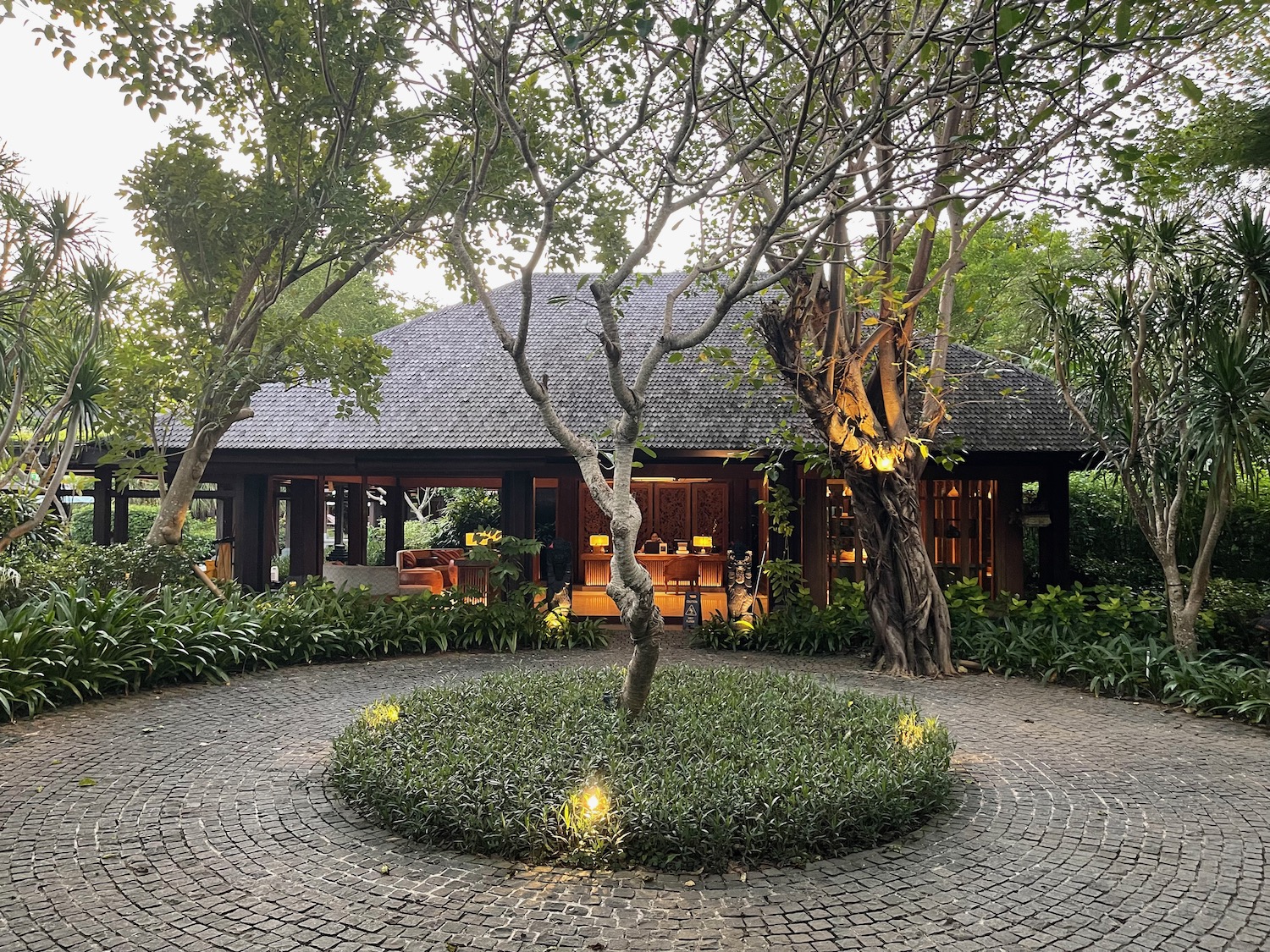 a circular stone walkway with trees around it