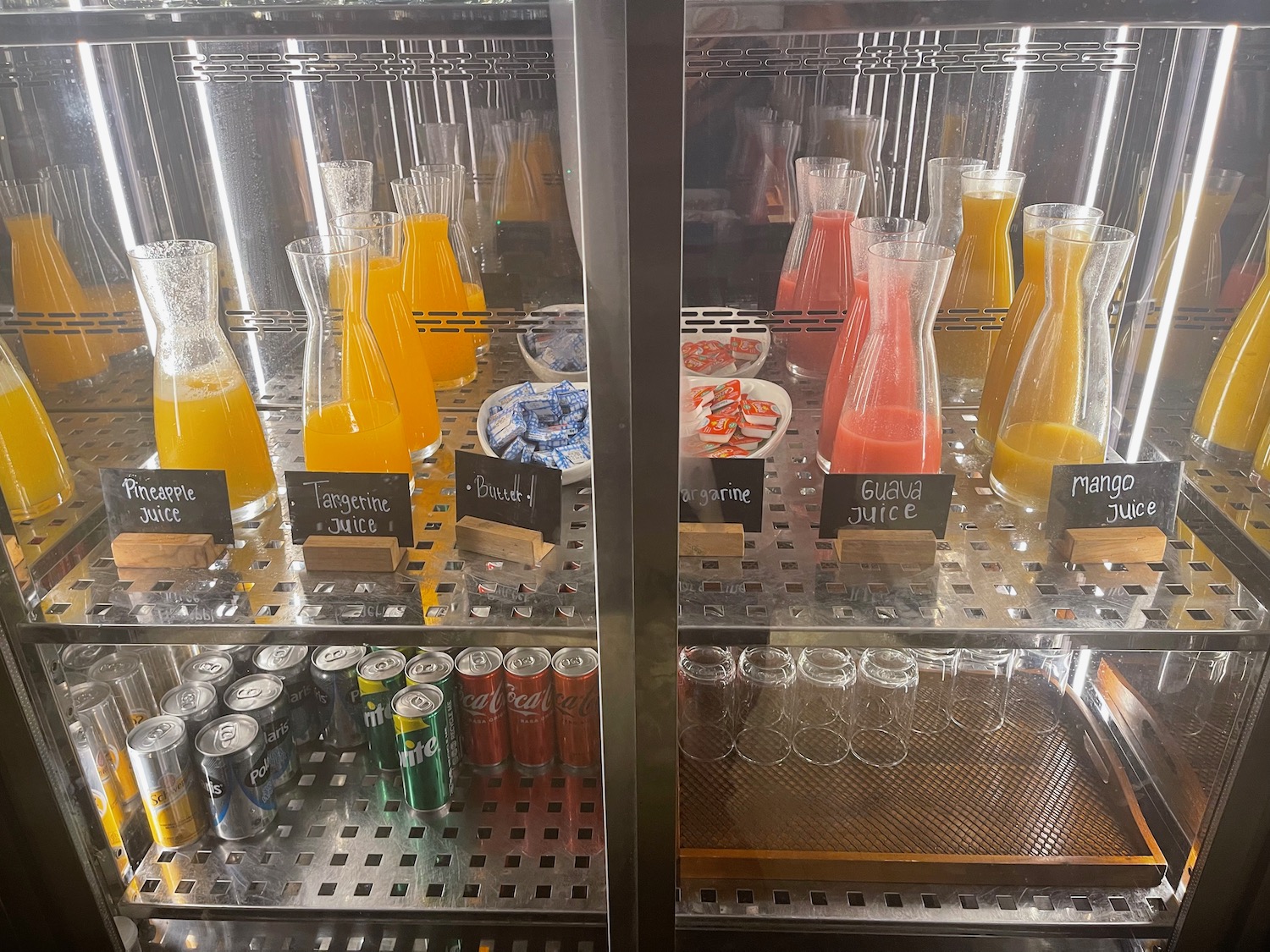 a display case with drinks and cans