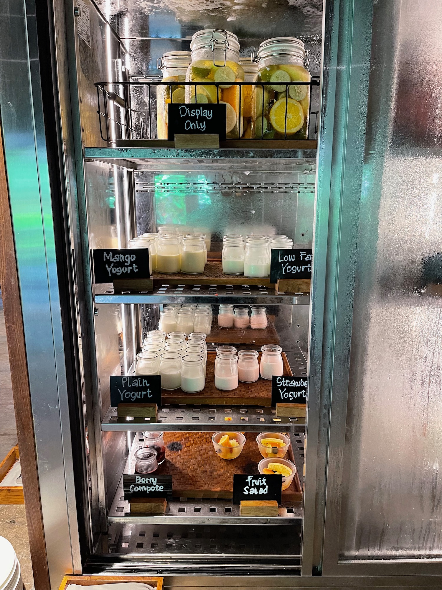 a refrigerator with different foods on shelves