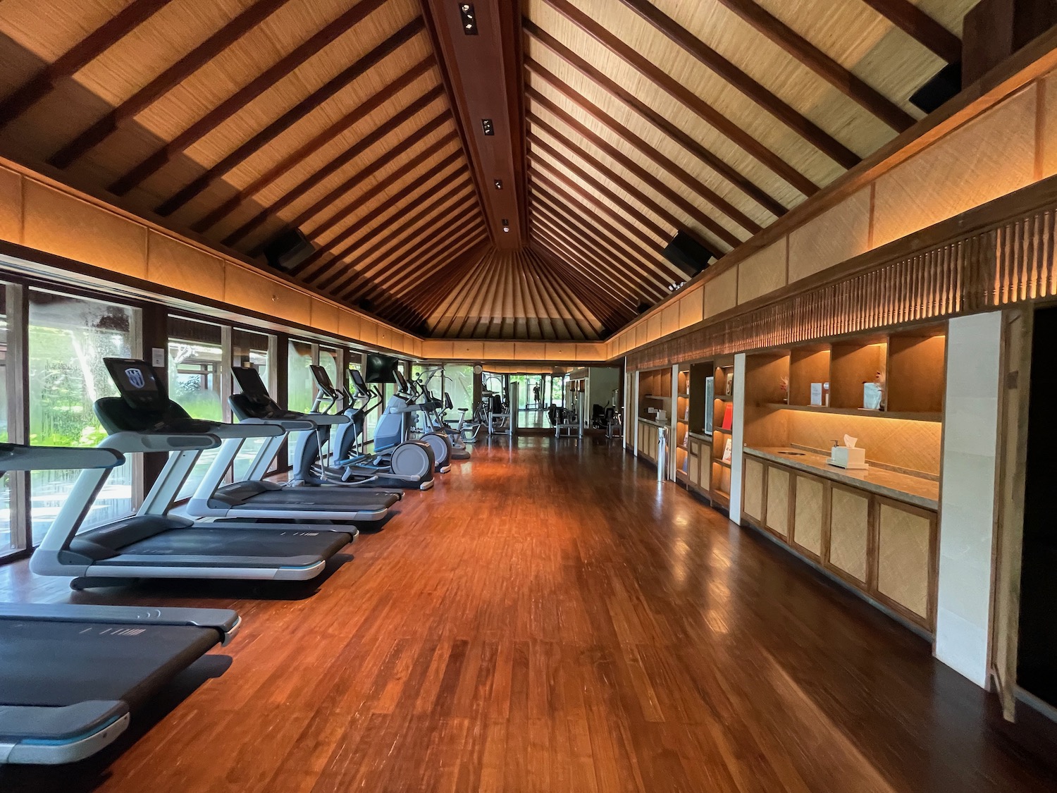 a room with treadmills and a wood floor