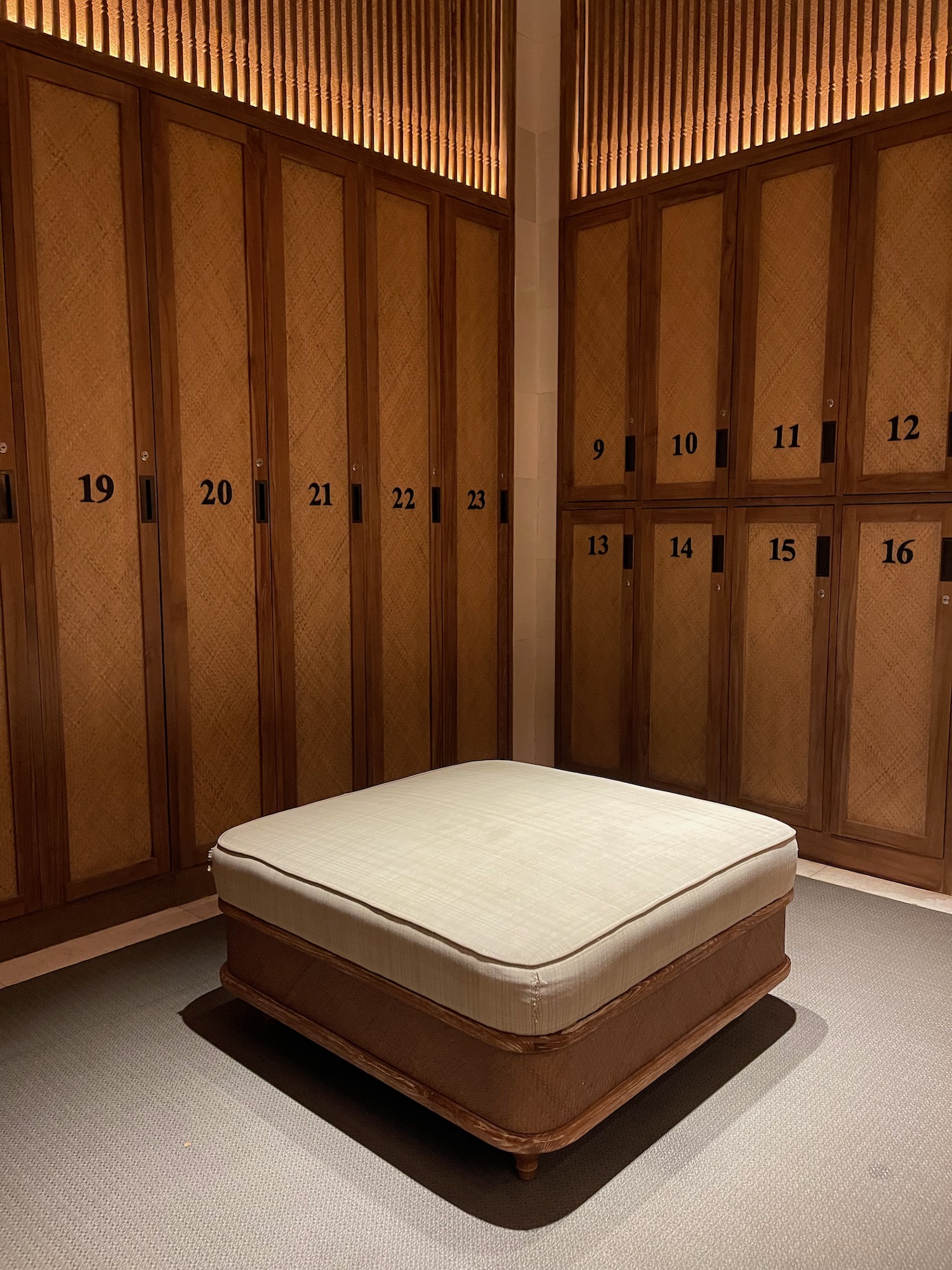 a room with a white cushion and lockers