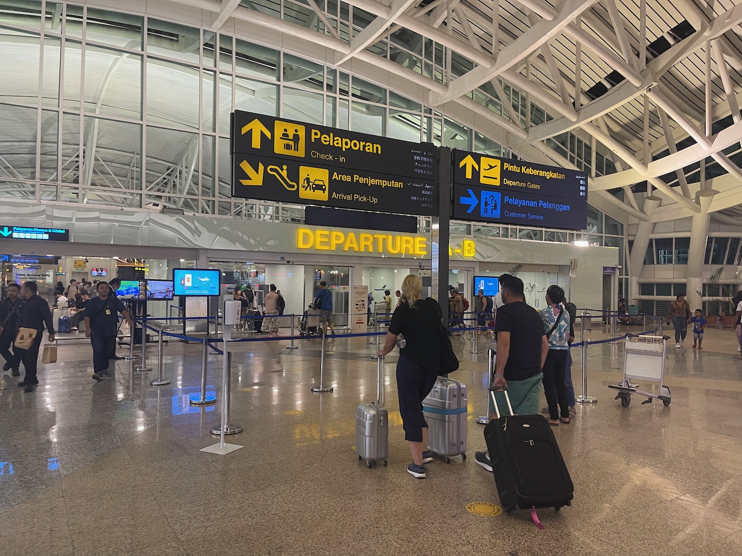 people in an airport with luggage