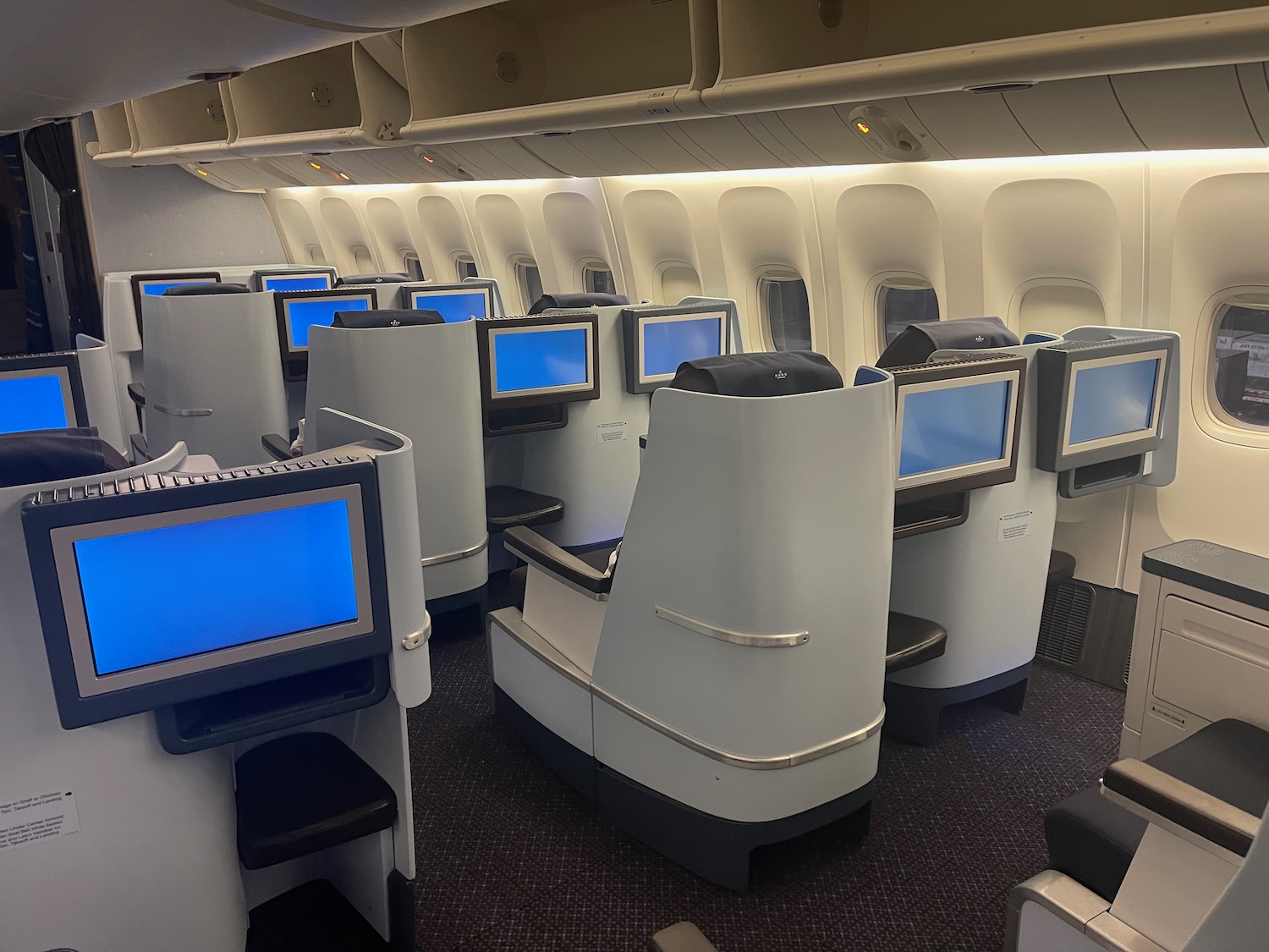 a row of seats with monitors on the side