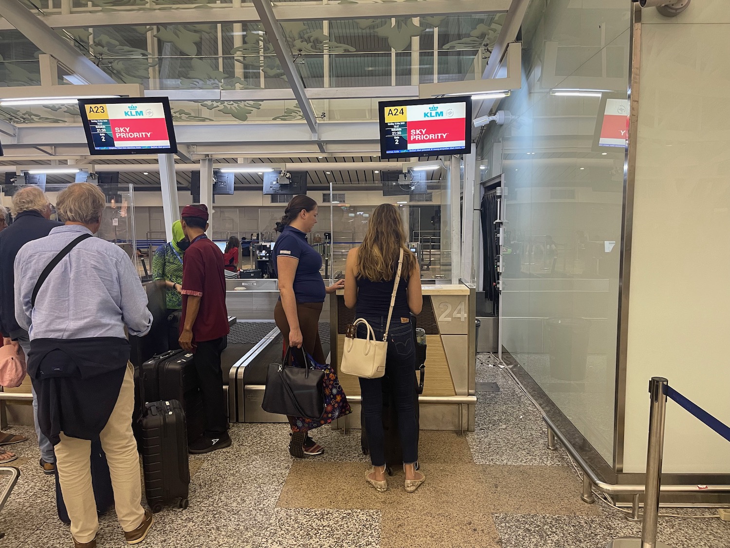 people standing in a line at an airport