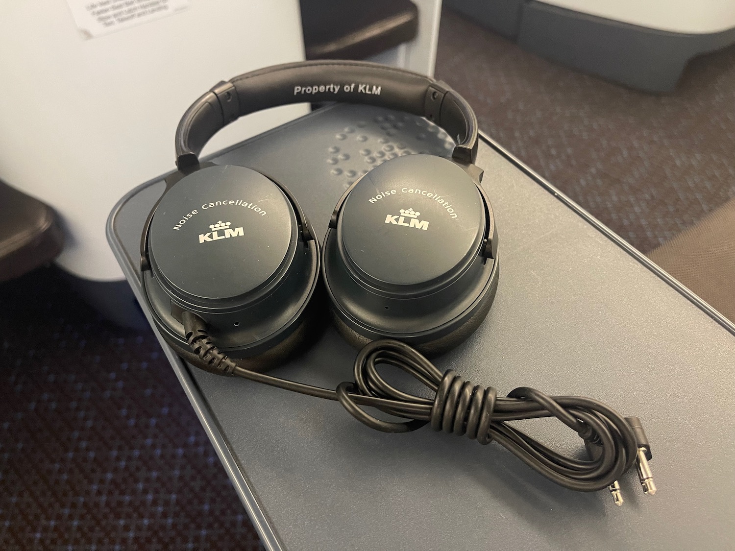 a pair of black headphones on a grey surface