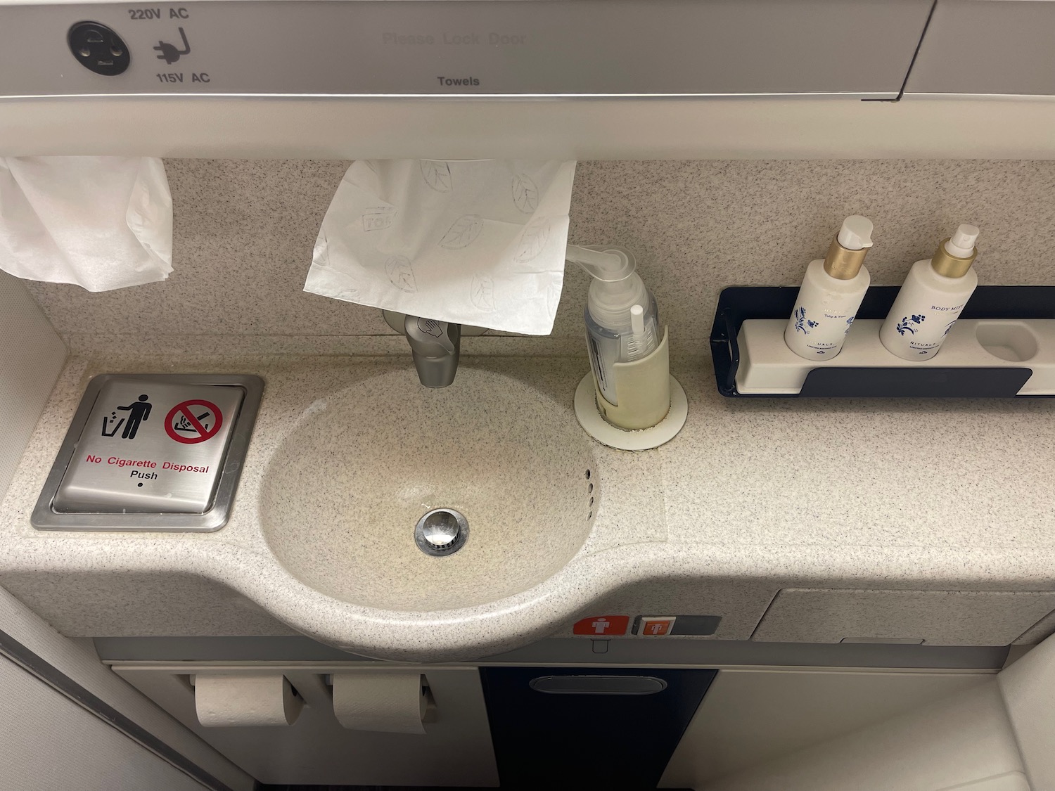 a sink with a soap dispenser and a soap dispenser