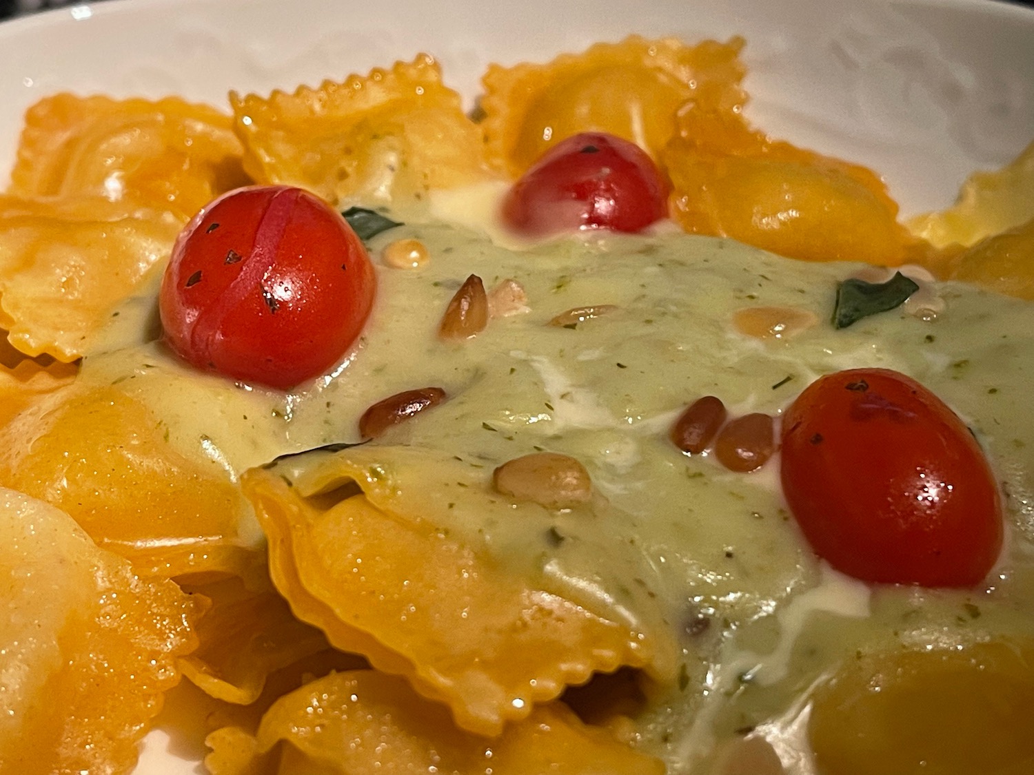 a plate of pasta with cheese and tomatoes