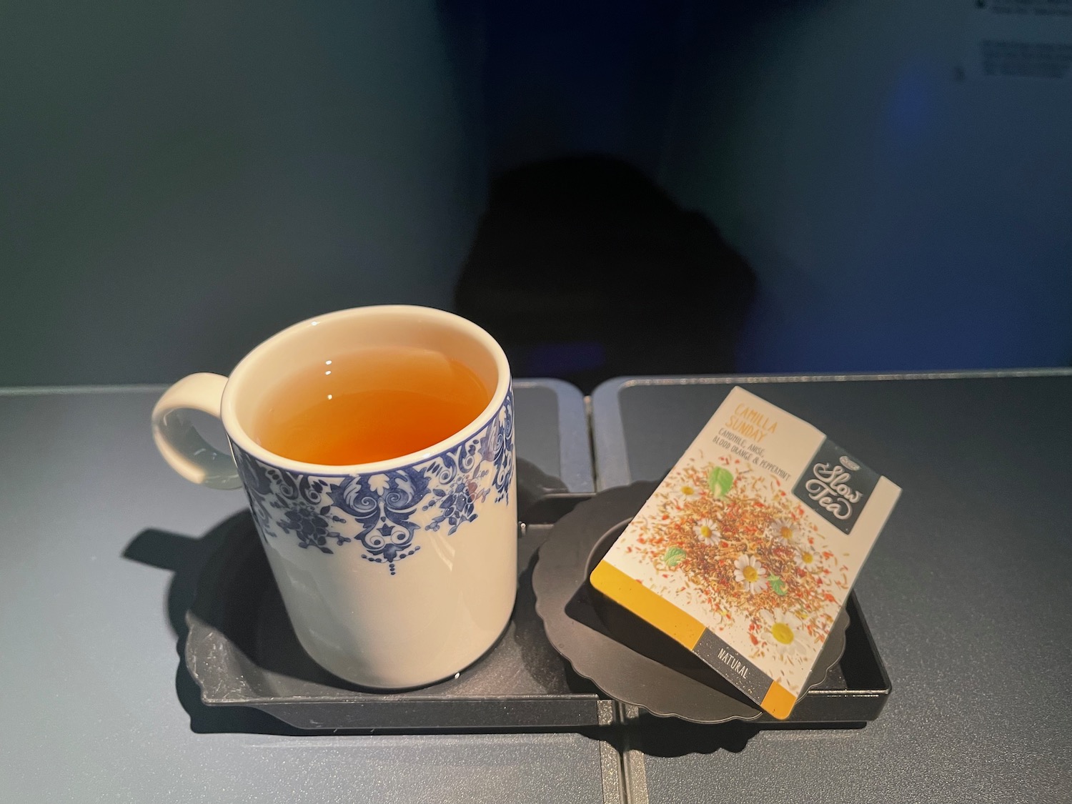 a cup of tea and a packet of tea on a tray