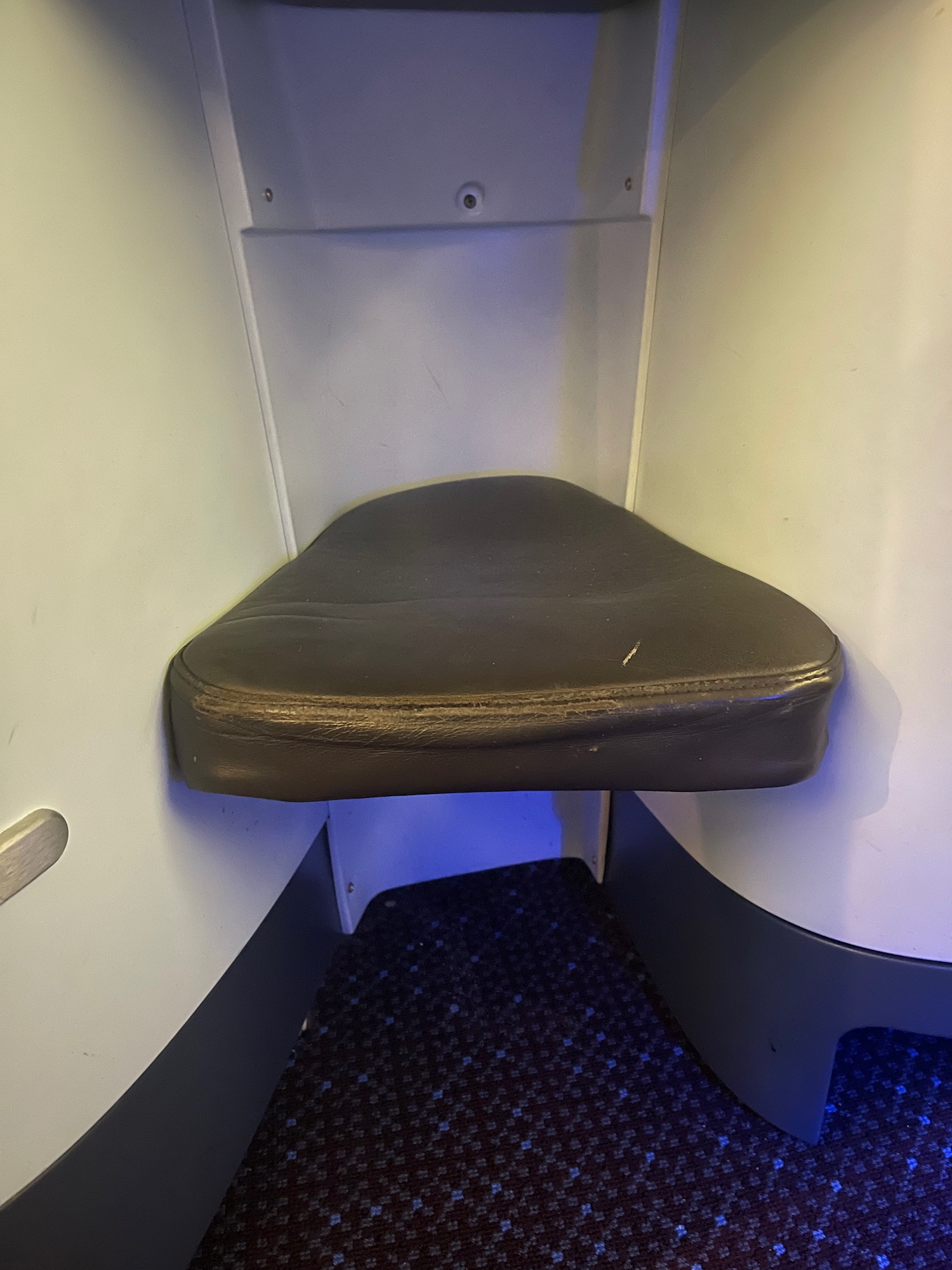 a seat in a corner of a plane