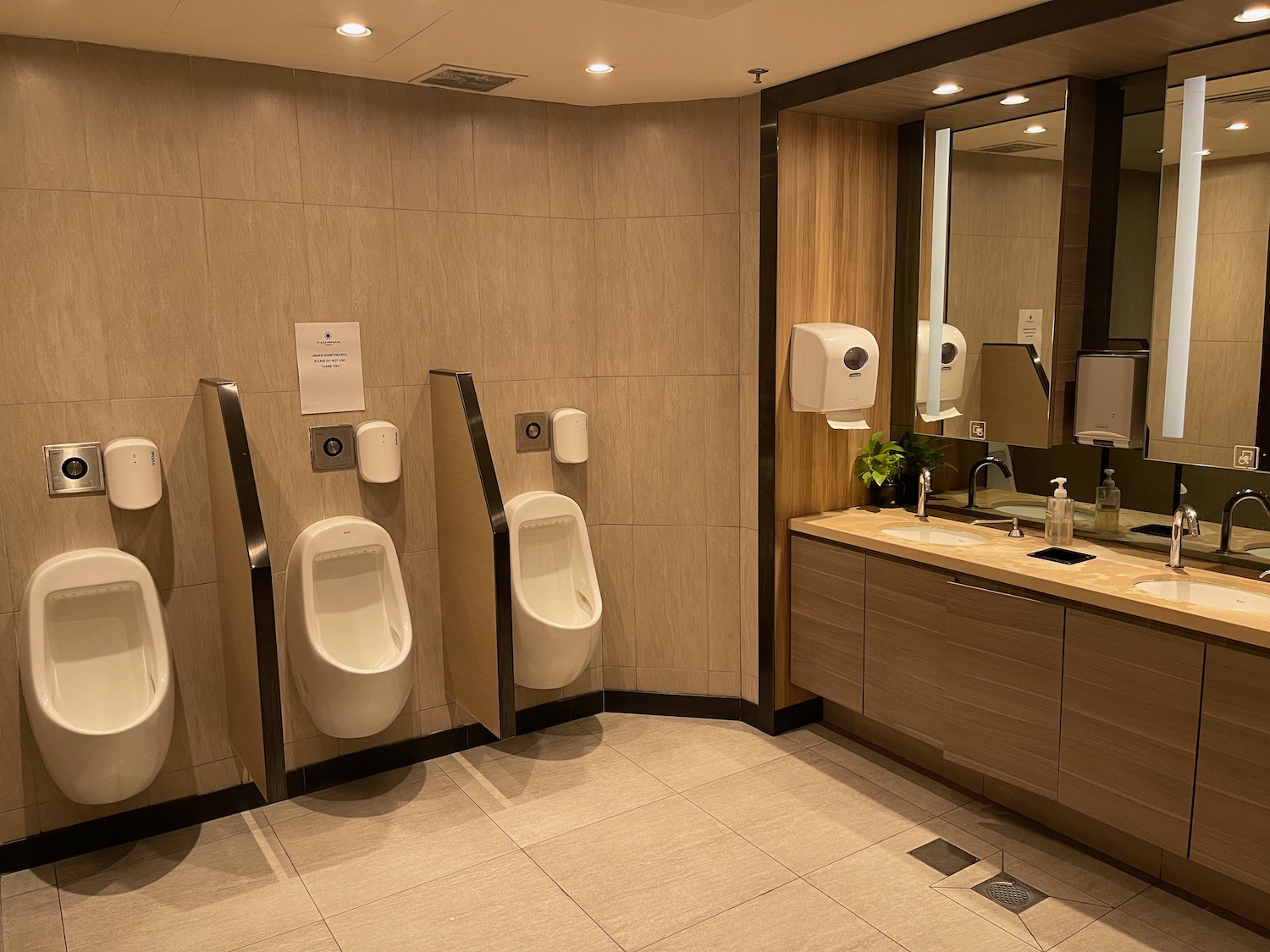 a bathroom with urinals and sink